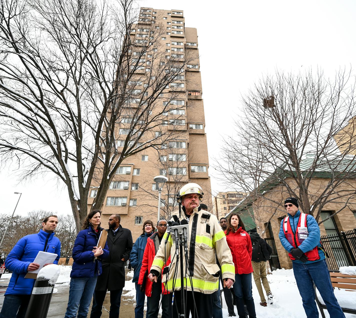 Minneapolis Fire Department Chief John Fruetel speaks to the media in front of the building at 630 Cedar Avenue where an early morning fire killed multiple people Wednesday, Nov. 27, 2019 in Minneapolis. Residents of the high rise were evacuated early Wednesday after a fire broke out on the 14th floor of the building. (Aaron Lavinsky/Star Tribune via AP)