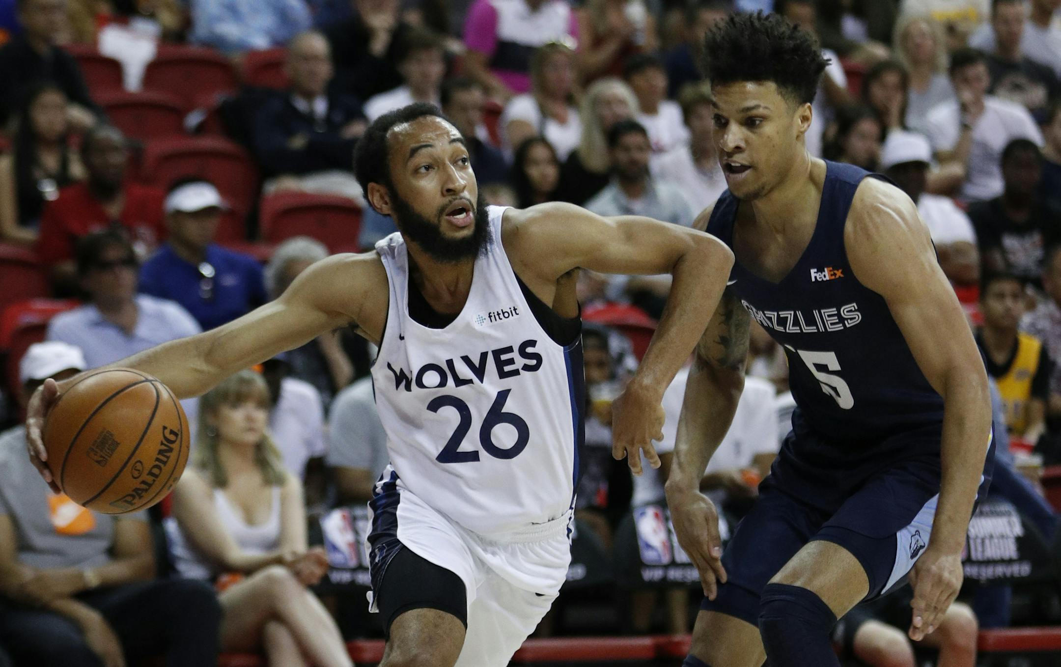 Minnesota Timberwolves' Jordan McLaughlin (26) drives around Memphis Grizzlies' Brandon Clarke during the first half of an NBA summer league basketball game Monday, July 15, 2019, in Las Vegas. (AP Photo/John Locher)