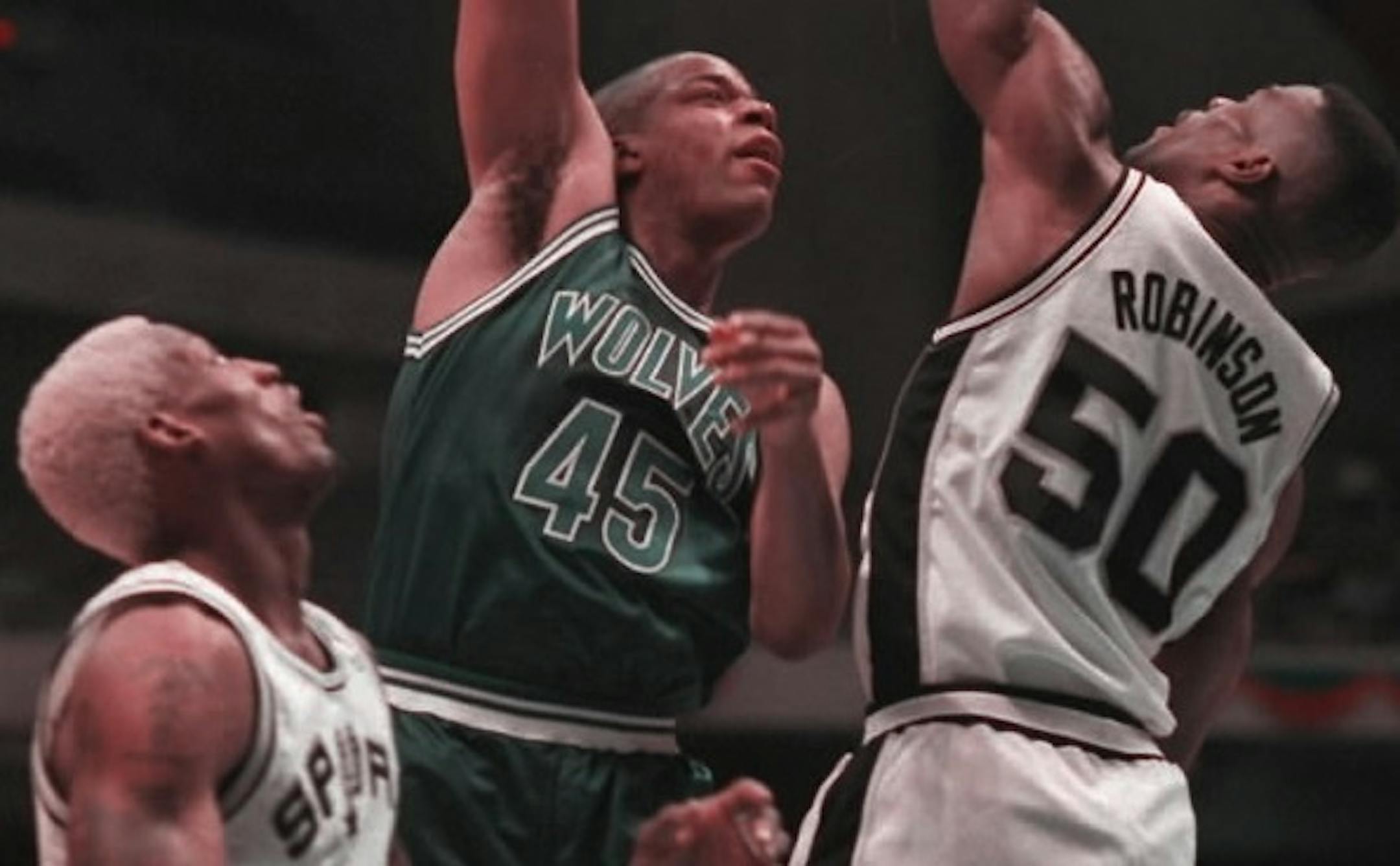 Sean Rooks is surrounded by David Robinson and Dennis Rodman of San Antonio during the 1994-95 season.