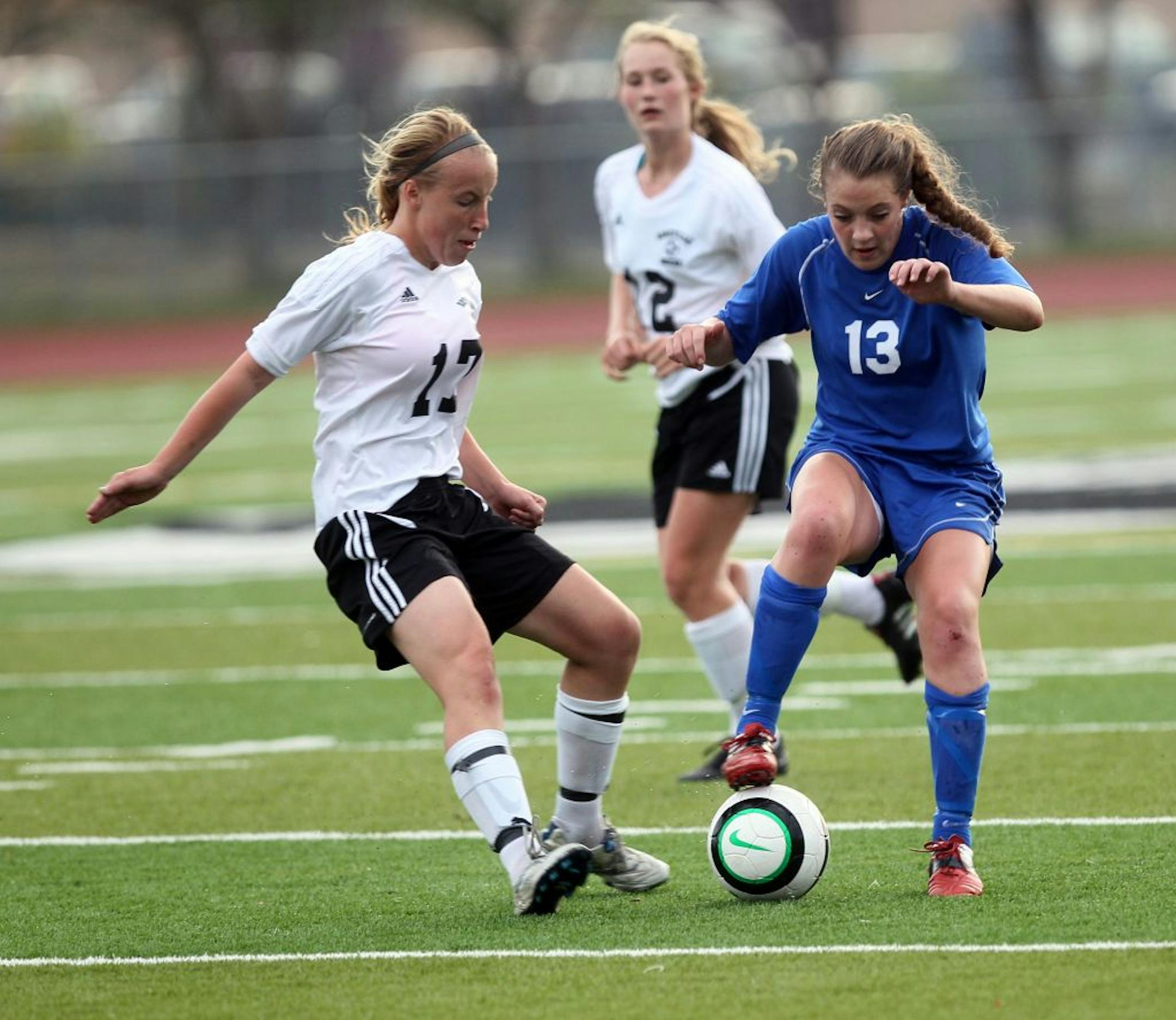 Woodbury's Lauren Nash kept possession of the ball against Roseville's Emma Schaefer in the second half of the game at Roseville, Minn. September 27, 2011. Woodbury won 2-1.