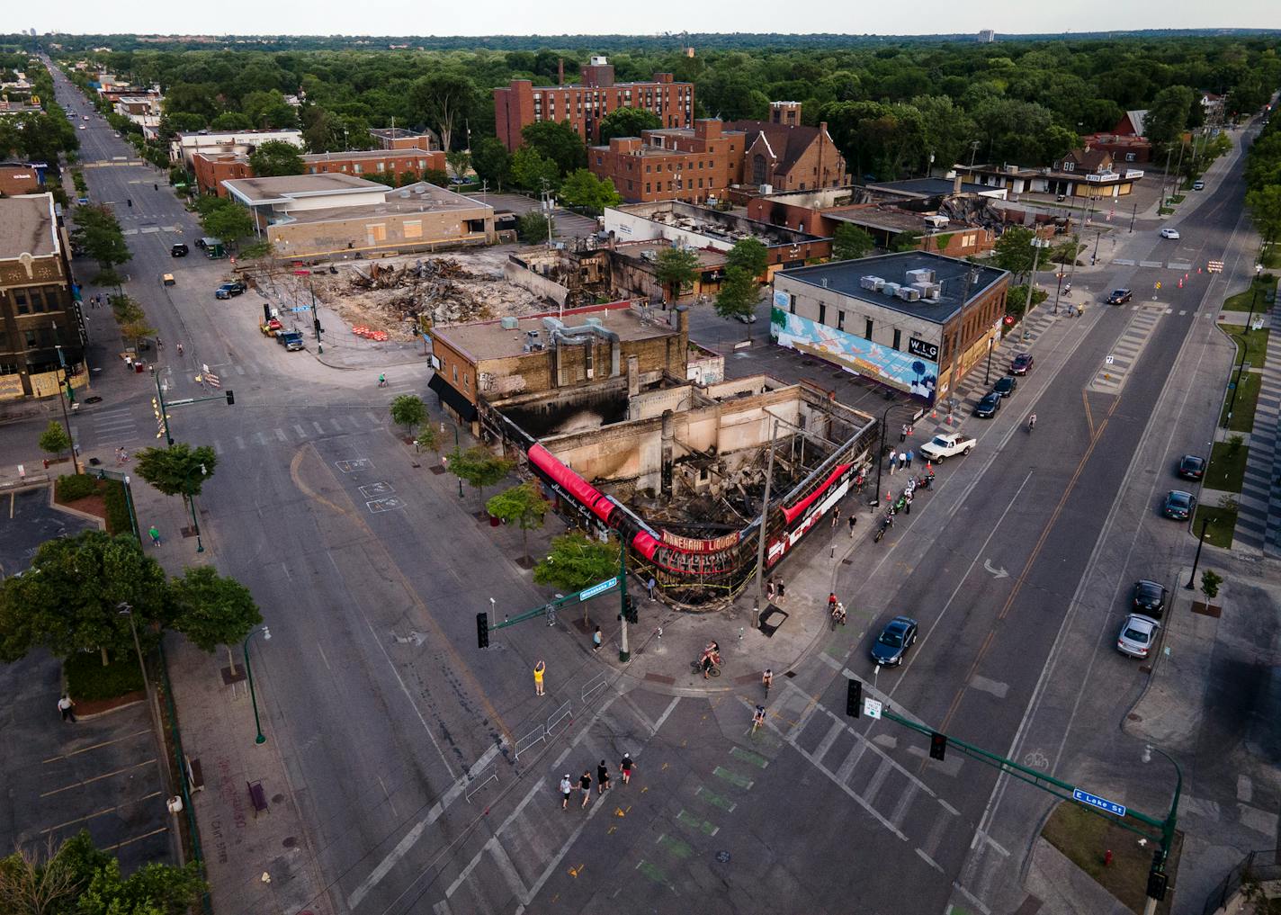 A view of some of the destruction near the Minneapolis Police Third Precinct last year, which included the burned-down Minnehaha Lake Wine and Spirits.