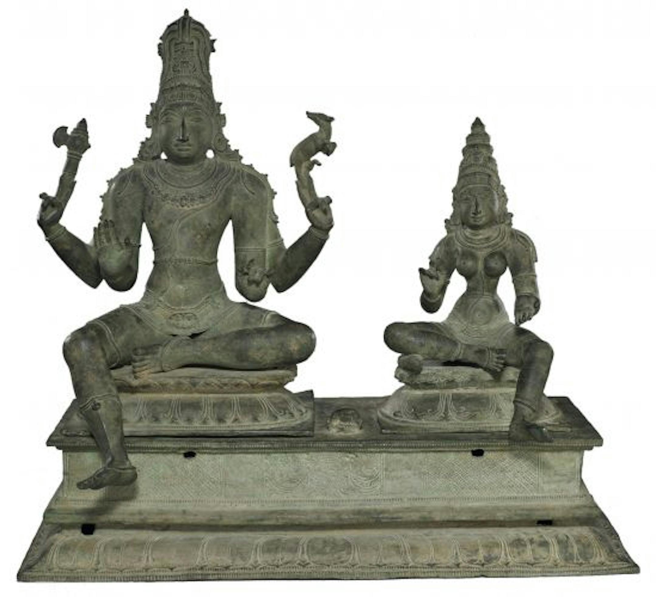 Elaborately coifed and bejeweled bronze figures � Shiva and Uma � seated on double-lotus thrones.