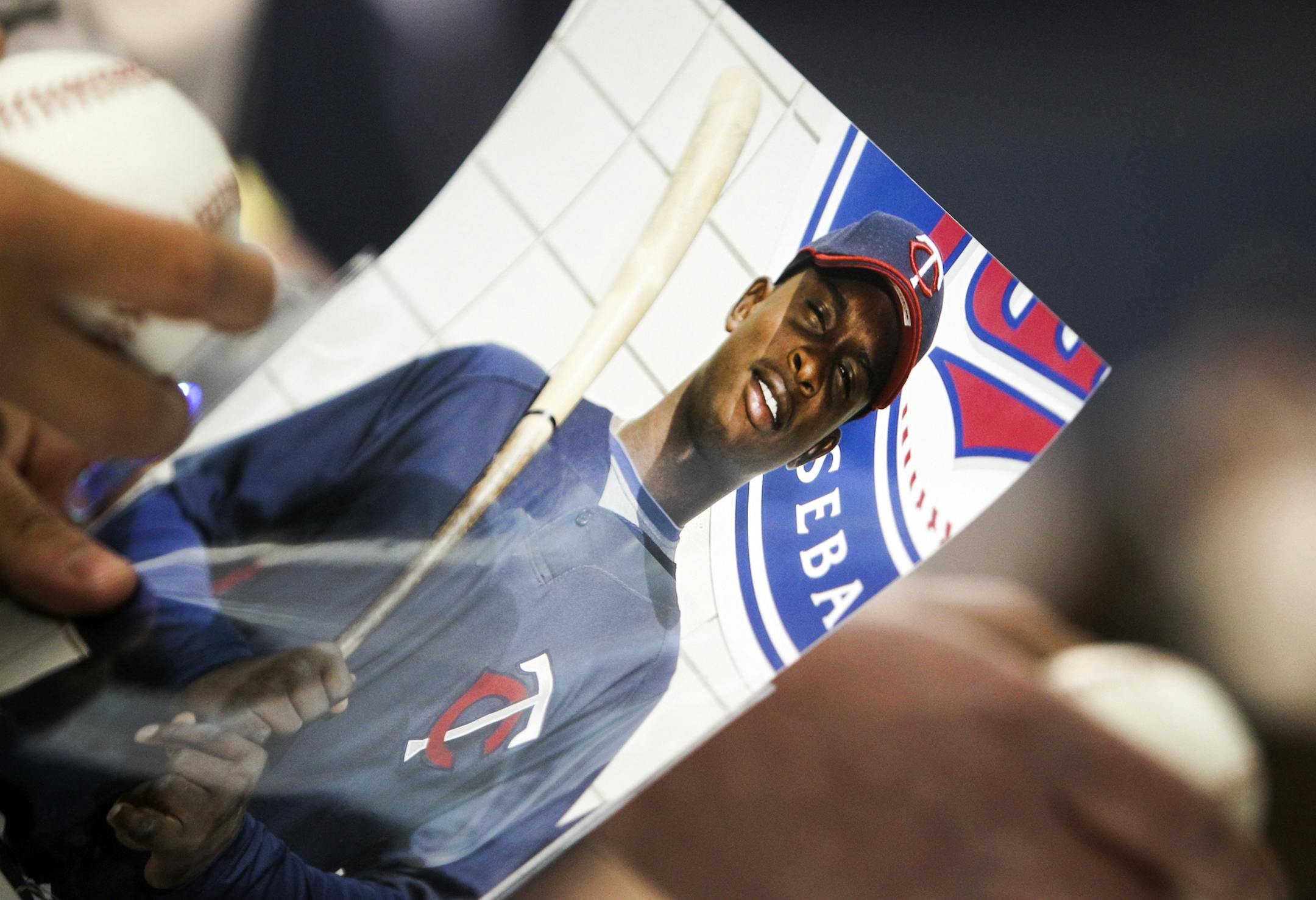 Sano signs autographs in 2013.
