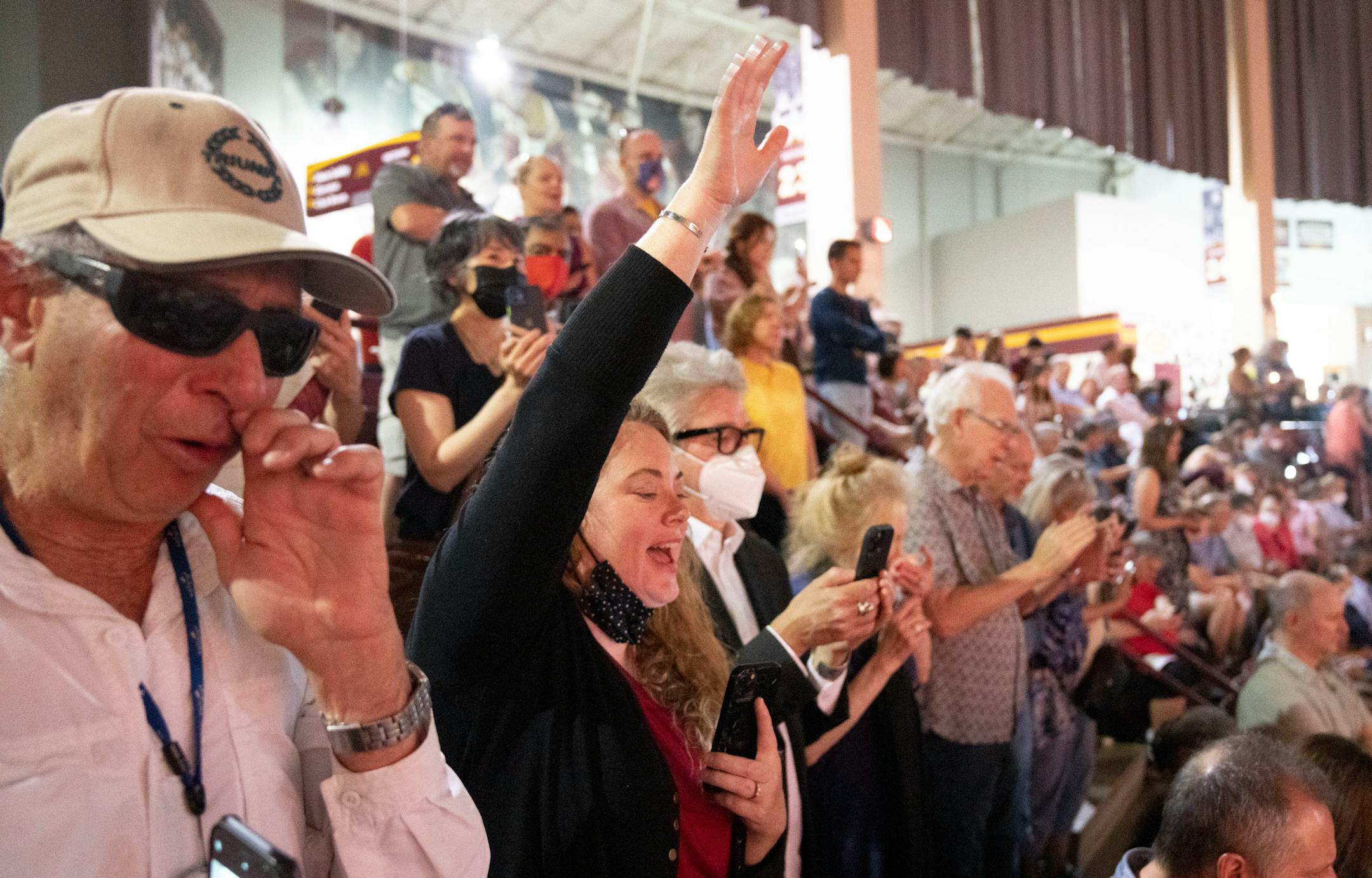 Michael Rottapel, a close family friend, Michelle Tanner and other family members of Elliott Tanner, 13, wave at him during his graduation.