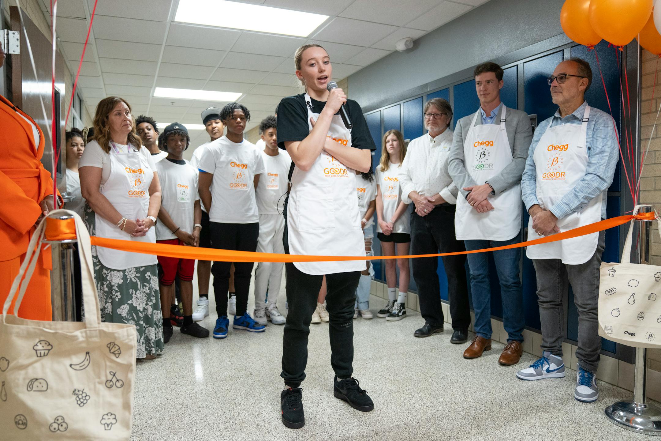 Paige Bueckers speaks during a grand opening ceremony for a new free grocery store.