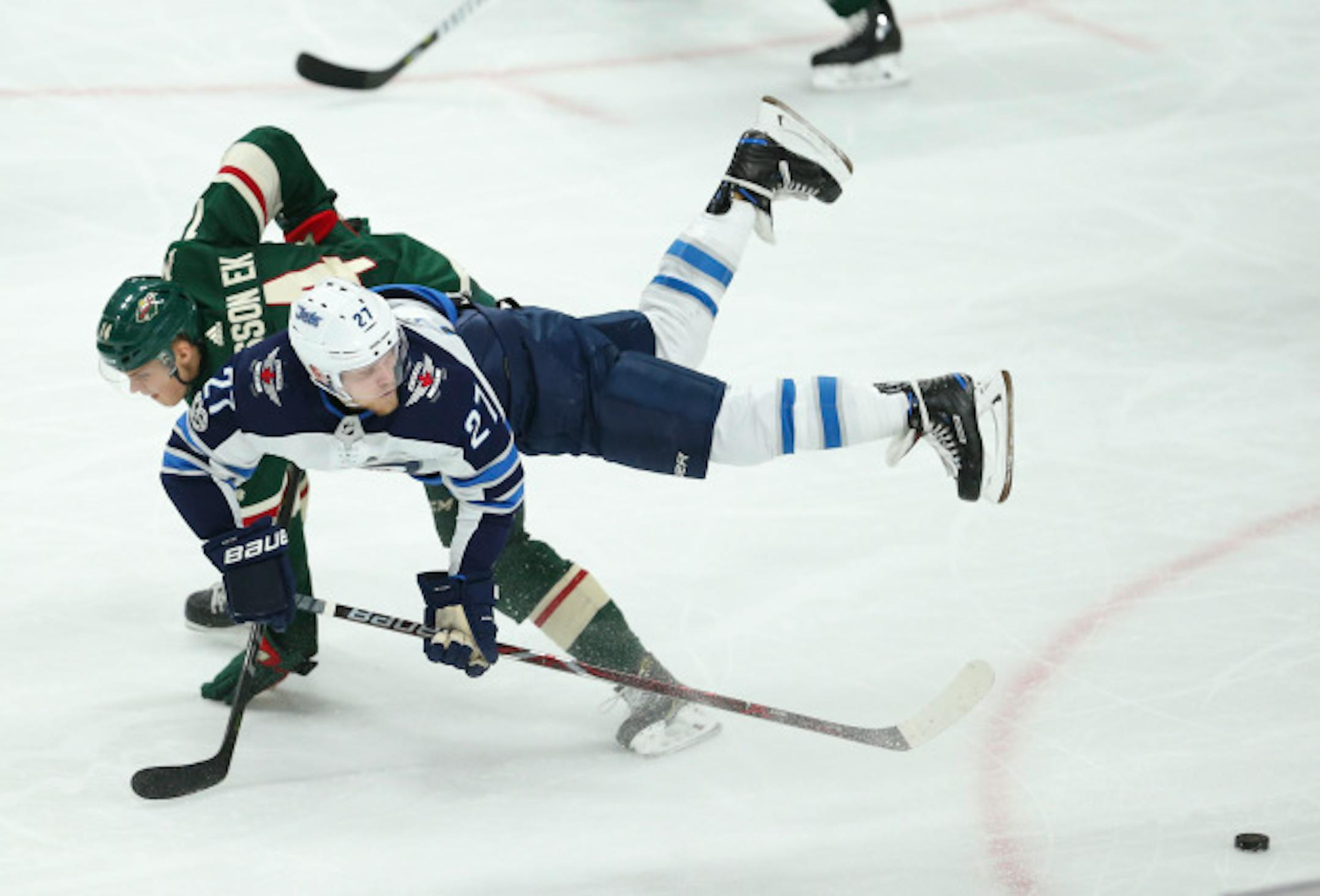 The Minnesota Wild's Joel Eriksson Ek (14) is upended by the Winnipeg Jets' Nikolaj Ehlers (27) as he deflects a pass in the second period on Tuesday, Oct. 31, 2017, at Xcel Energy Center in St. Paul, Minn. (Jeff Wheeler/Minneapolis Star Tribune/TNS) ORG XMIT: 1214758