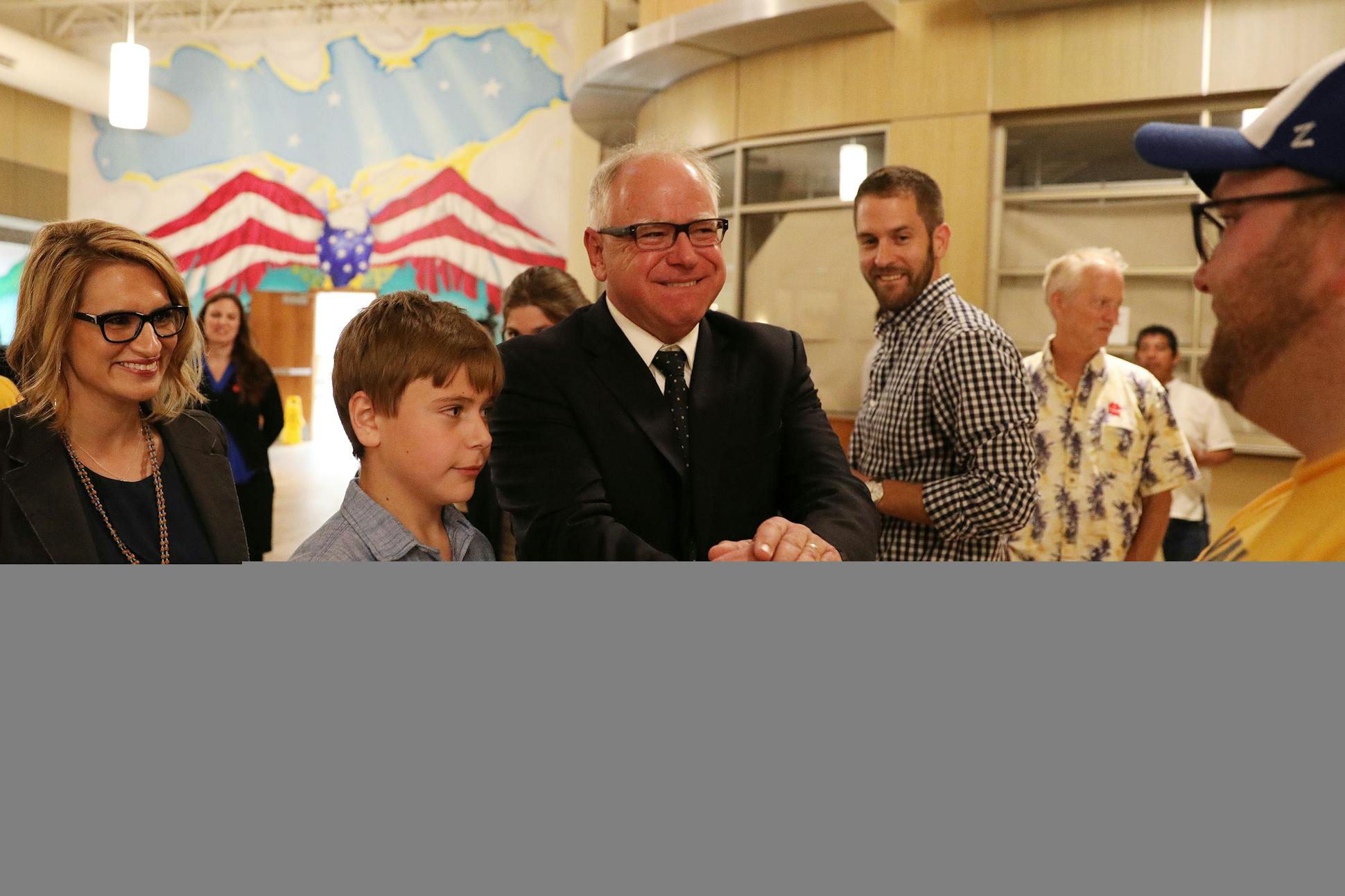 Walz, his son Gus, and his running mate Peggy Flanagan came out to greet supporters during their night party at the Carpenters Union Hall.