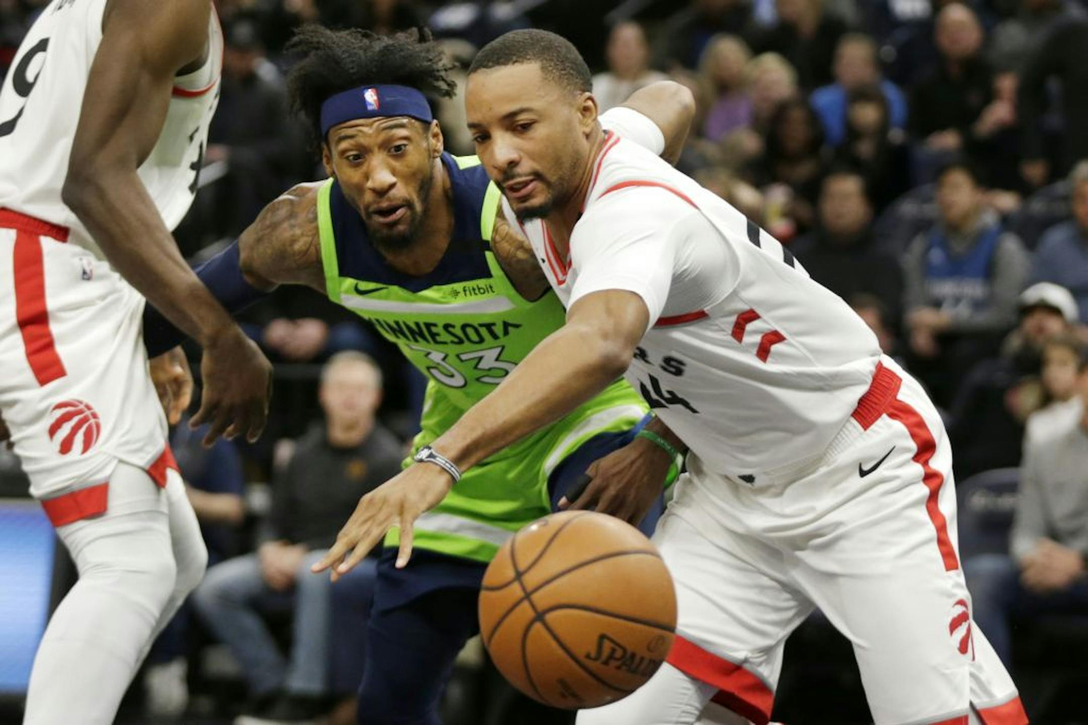 Toronto Raptors guard Norman Powell (24) and Minnesota Timberwolves forward Robert Covington (33) battle for the ball in the first quarter of an NBA basketball game Saturday, Jan. 18, 2020, in Minneapolis.