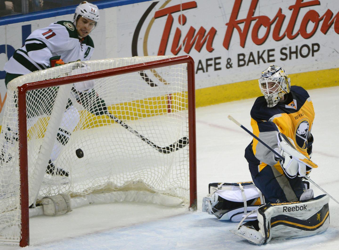 Minnesota Wild left winger Zach Parise (11) watches the puck beat Buffalo Sabres goaltender Jhonas Enroth (1), of Sweden, on a goal by Thomas Vanek during the first period of an NHL hockey game Thursday, Jan. 15, 2015, in Buffalo, N.Y. (AP Photo/Gary Wiepert)