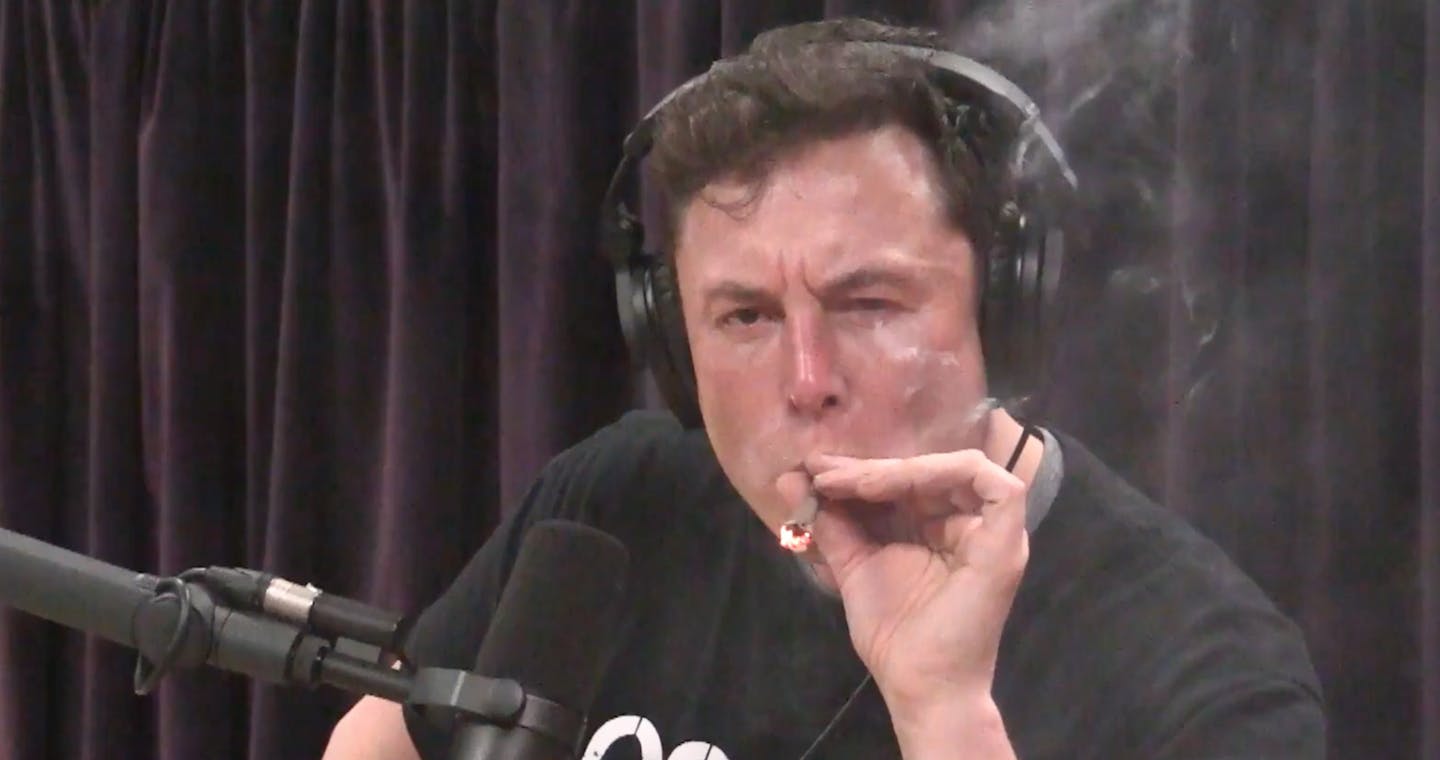 Elon Musk, chairman and CEO at Tesla and chairman of SpaceX, inhales what he said was marijuana on a live YouTube webcast Thursday night. (Screenshot/Youtube)