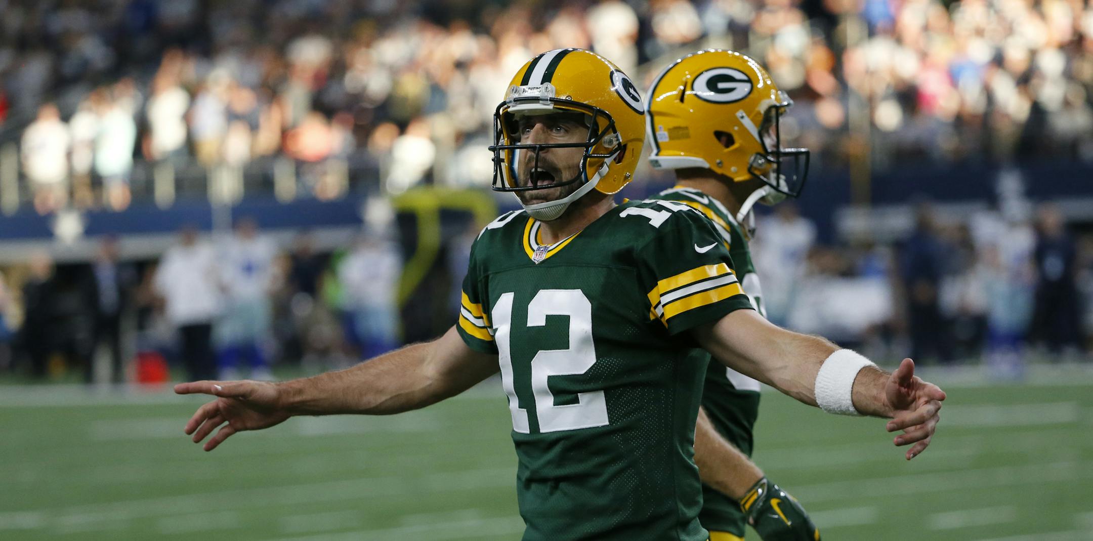 Green Bay Packers' Aaron Rodgers (12) celebrates a touchdown scored late in the second half of an NFL football game against the Dallas Cowboys on Sunday, Oct. 8, 2017, in Arlington, Texas. (AP Photo/Roger Steinman)