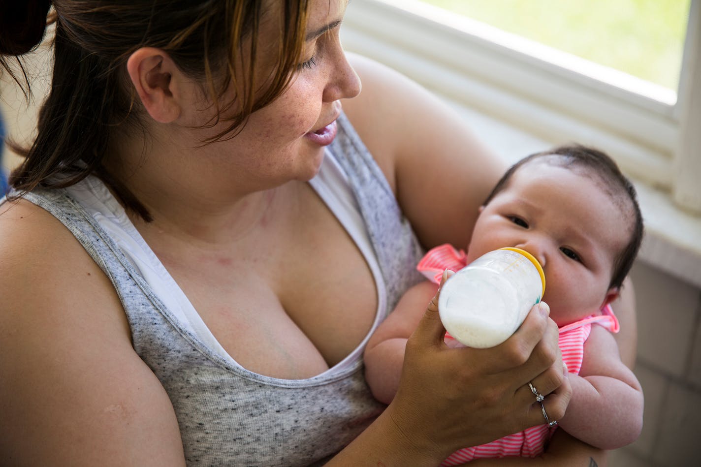 Raejean Icard feeds her two-month-old daughter Eniya at her mother's house in St. Paul the day she was released from Shakopee women's prison. Icard is hoping to be able to breastfeed her daughter, as she was able to pump milk in prison to keep up production.