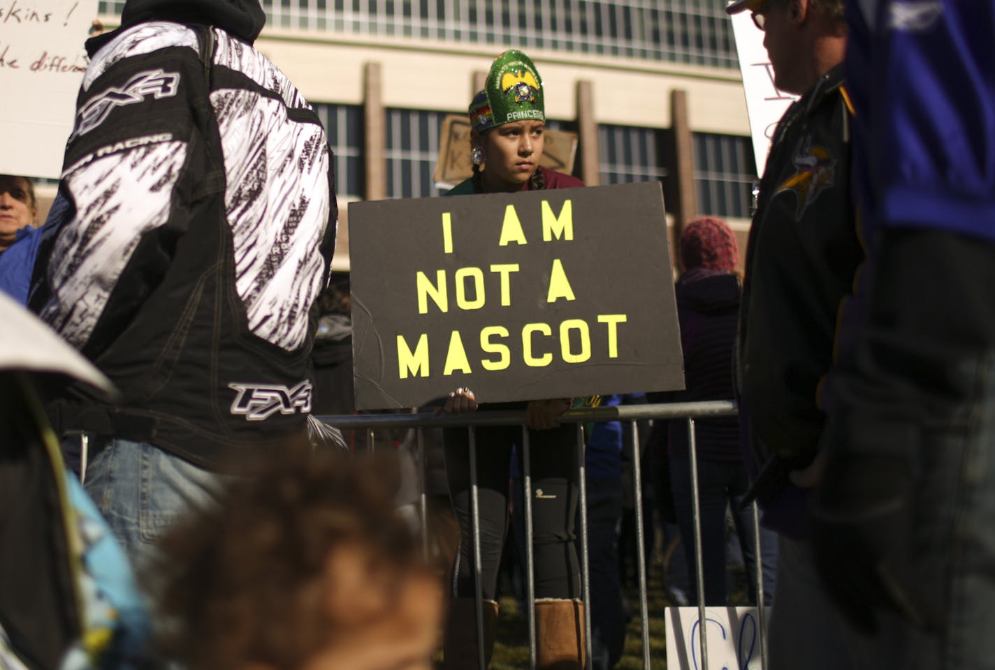 As football fans arrived for the Vikings game, Summer Blackhawk held a sign near her dad, Bradley Blackhawk, left, as they stood with demonstrators holding a rally outside TCF Bank Stadium Sunday morning before the Vikings game. ] JEFF WHEELER &#x201a;&#xc4;&#xa2; jeff.wheeler@startribune.com A rally to protest the name of the Washington Redskins football club was held at TCF Bank Stadium before Sunday's Vikings game against the team from Washington on November 2, 2014.