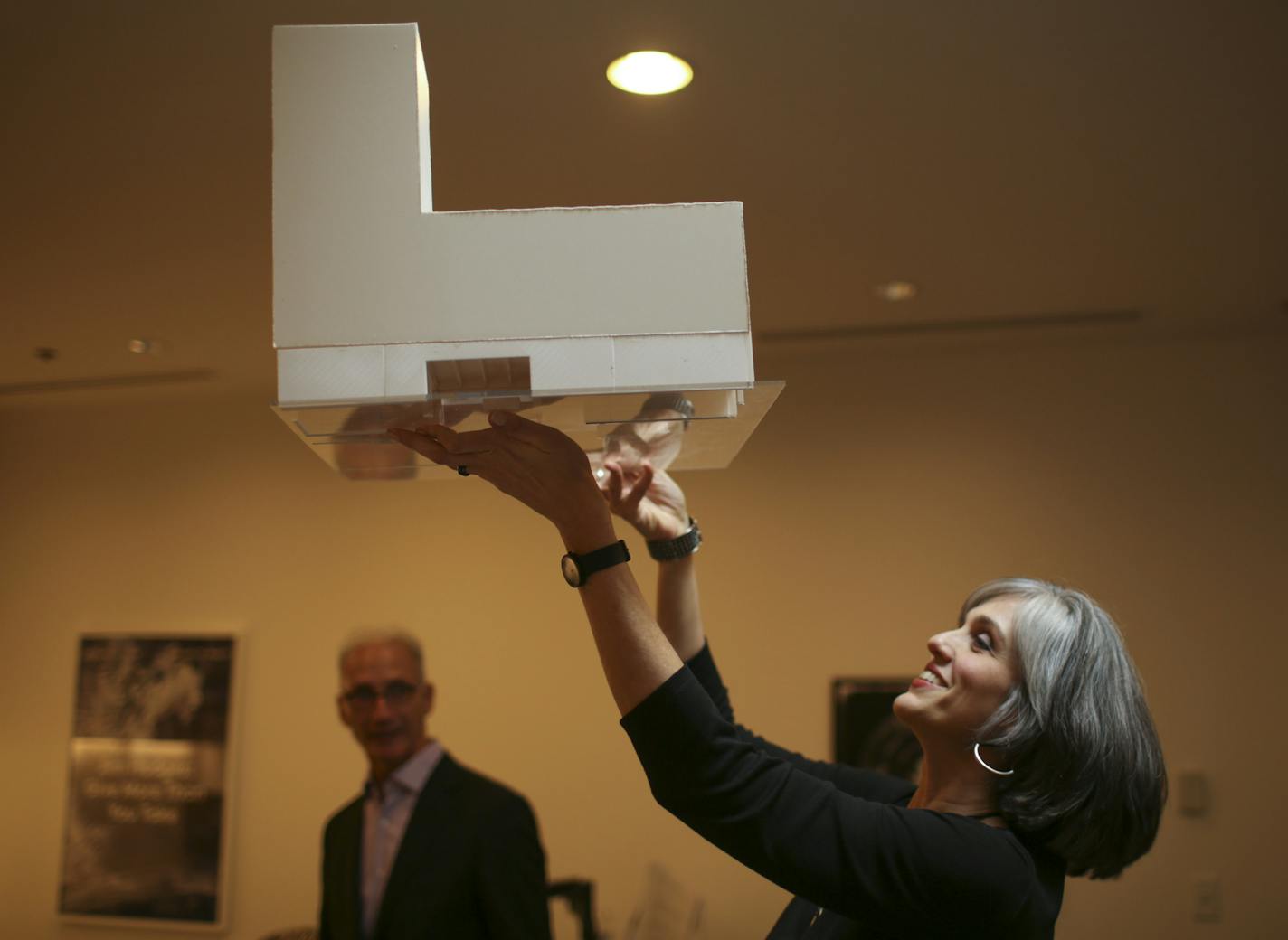 In her office Tuesday afternoon, Walker Art Center director Olga Viso held up the architect's model to show renovations that will begin this fall. With her at left was John Cook of HGA, one of the two architects who are working on the project. ] JEFF WHEELER &#x2022; jeff.wheeler@startribune.com Coinciding nicely with the museum's 75th anniversary, director Olga Viso of the Walker Art Center gave a sneak preview Tuesday, March 24, 2015 of extensive renovations made possible by a $75 million capi