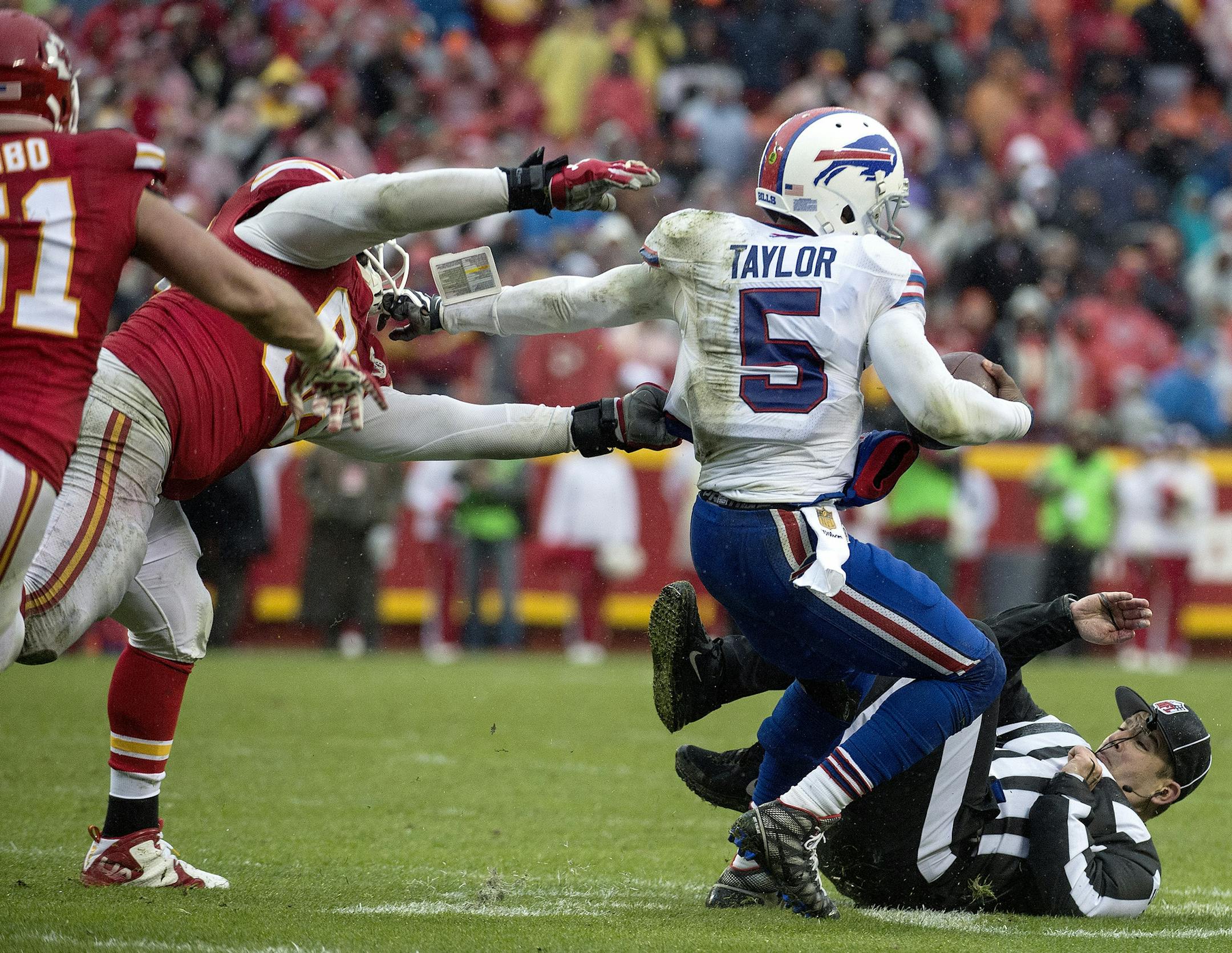 Buffalo Bills quarterback Tyrod Taylor (5) is slowed up by Kansas City Chiefs Jaye Howard (96) to allow Frank Zombo (51) to bring down Taylor on a two point conversion attempt in the third quarter on Nov. 29, 2015 at Arrowhead Stadium in Kansas City, Mo. The Chiefs won 30-22. (John Sleezer/Kansas City Star/TNS)