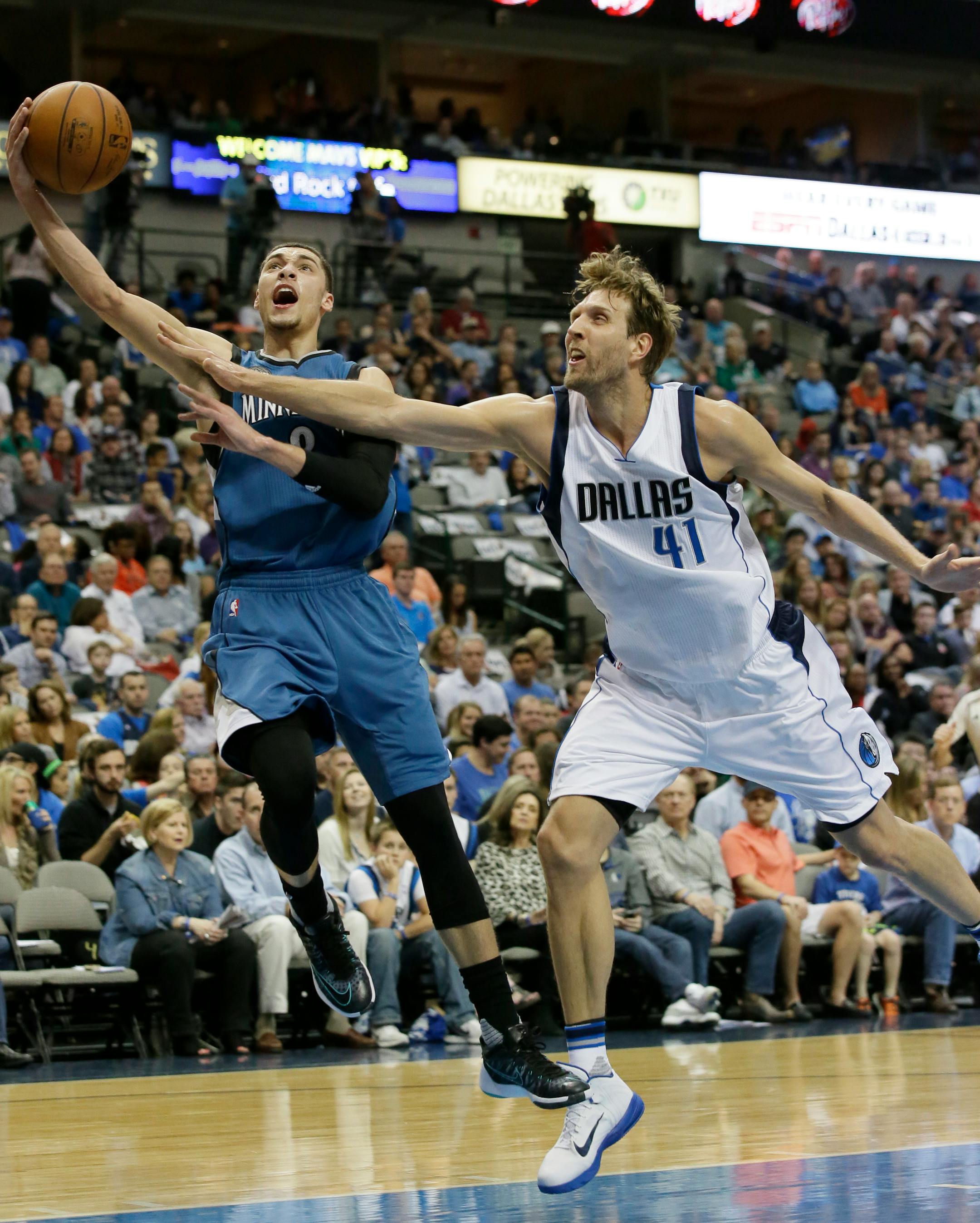 Minnesota Timberwolves guard Zach LaVine (8) drives against Dallas Mavericks forward Dirk Nowitzki (41) during the first half of an NBA basketball game Sunday, Feb. 28, 2016, in Dallas. (AP Photo/LM Otero)