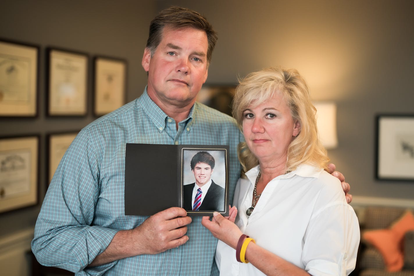 Jake Anderson's parents Bill and Kristi hold a photograph of him. "There are just so many questions," she said.