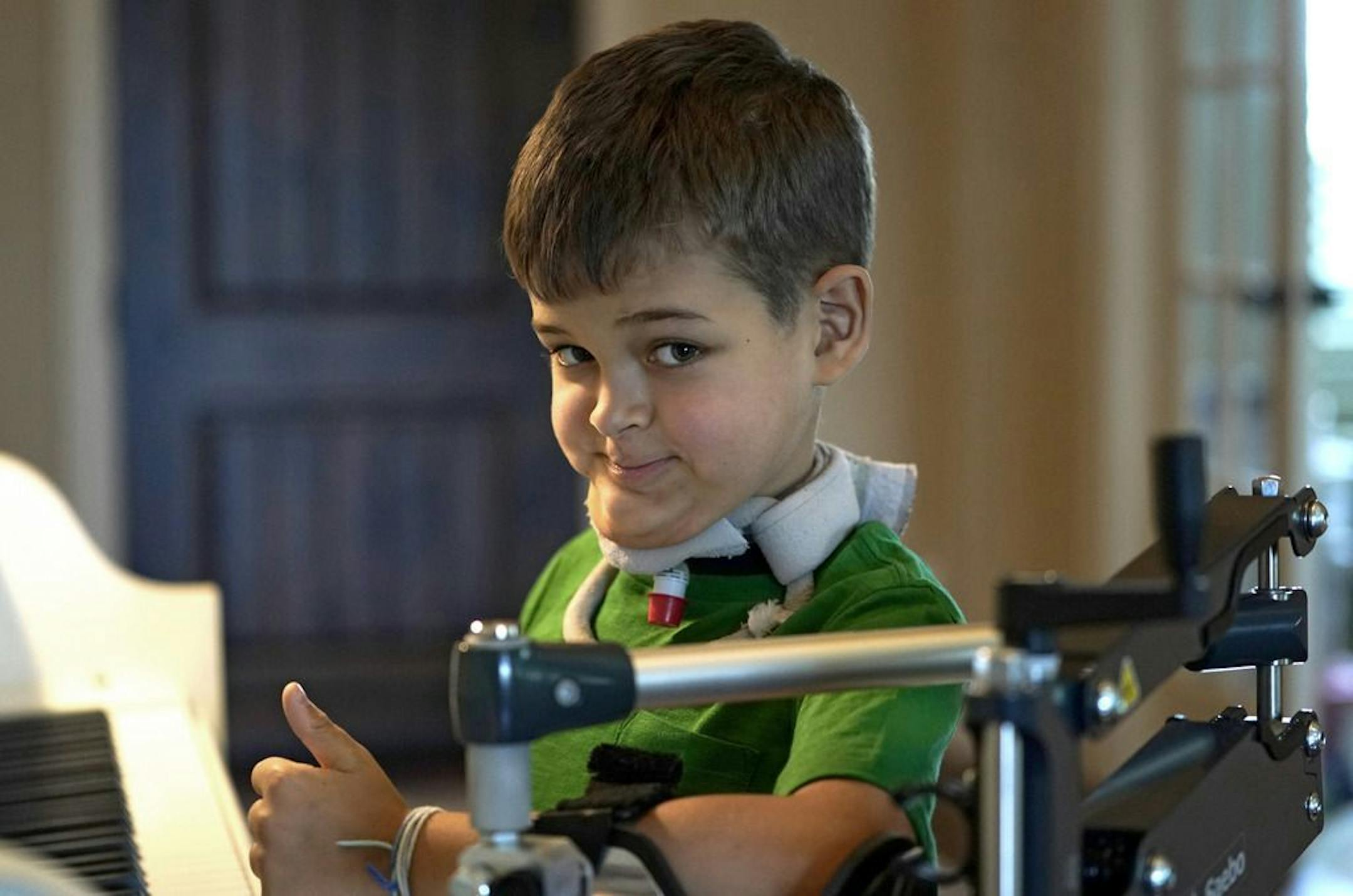 Braden Scott gives a thumbs up as he pauses while practicing on the piano in Tomball, Texas on Friday, March 29, 2019. Braden was diagnosed with the mysterious syndrome called acute flaccid myelitis, or AFM, in 2016 and was paralyzed almost completely. But since then he has recovered much of his muscle function. His parents believe a lot of it has to do with thousands of hours of physical therapy.