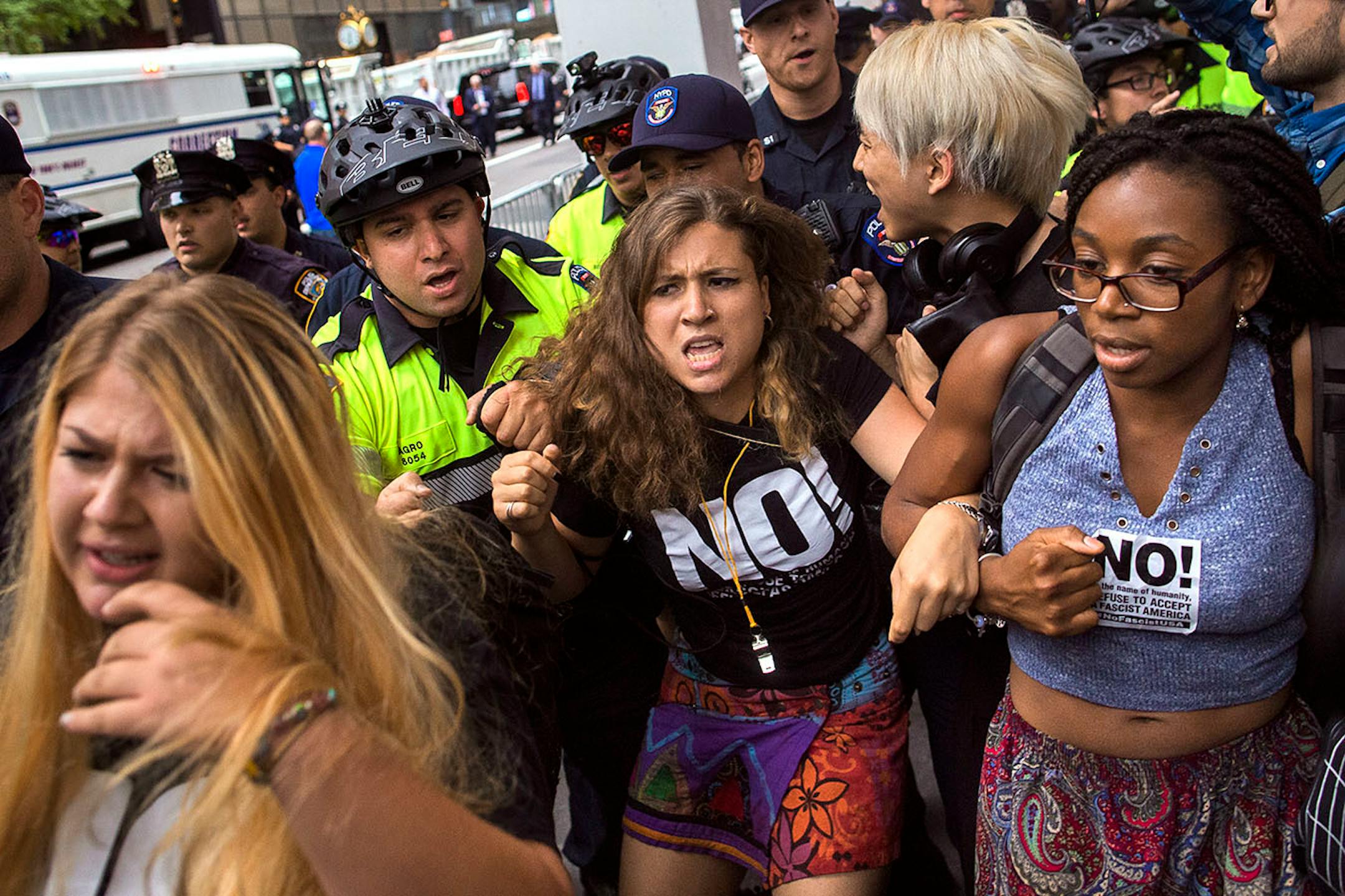Police remove protestor from the front of Trump Tower ahead President Donald Trump's first visit to the building since taking office, New York, Monday, Aug. 14, 2017.