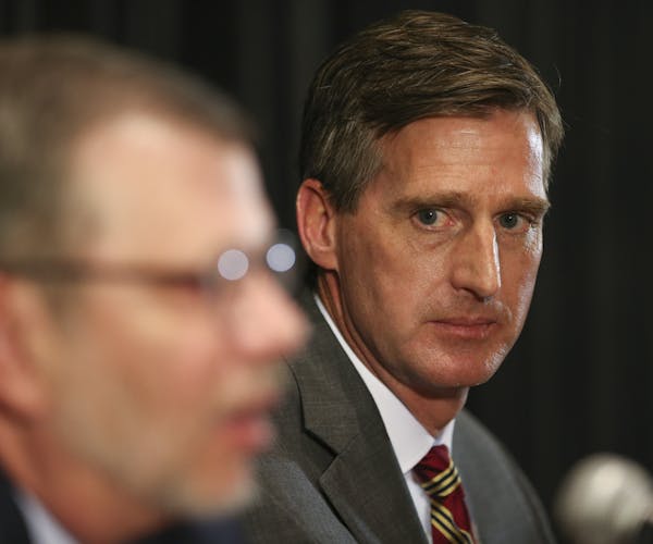 Former Syracuse athletic director Mark Coyle, shown with President Eric Kaler, arrives this week to take the helm as the new AD for the University of 