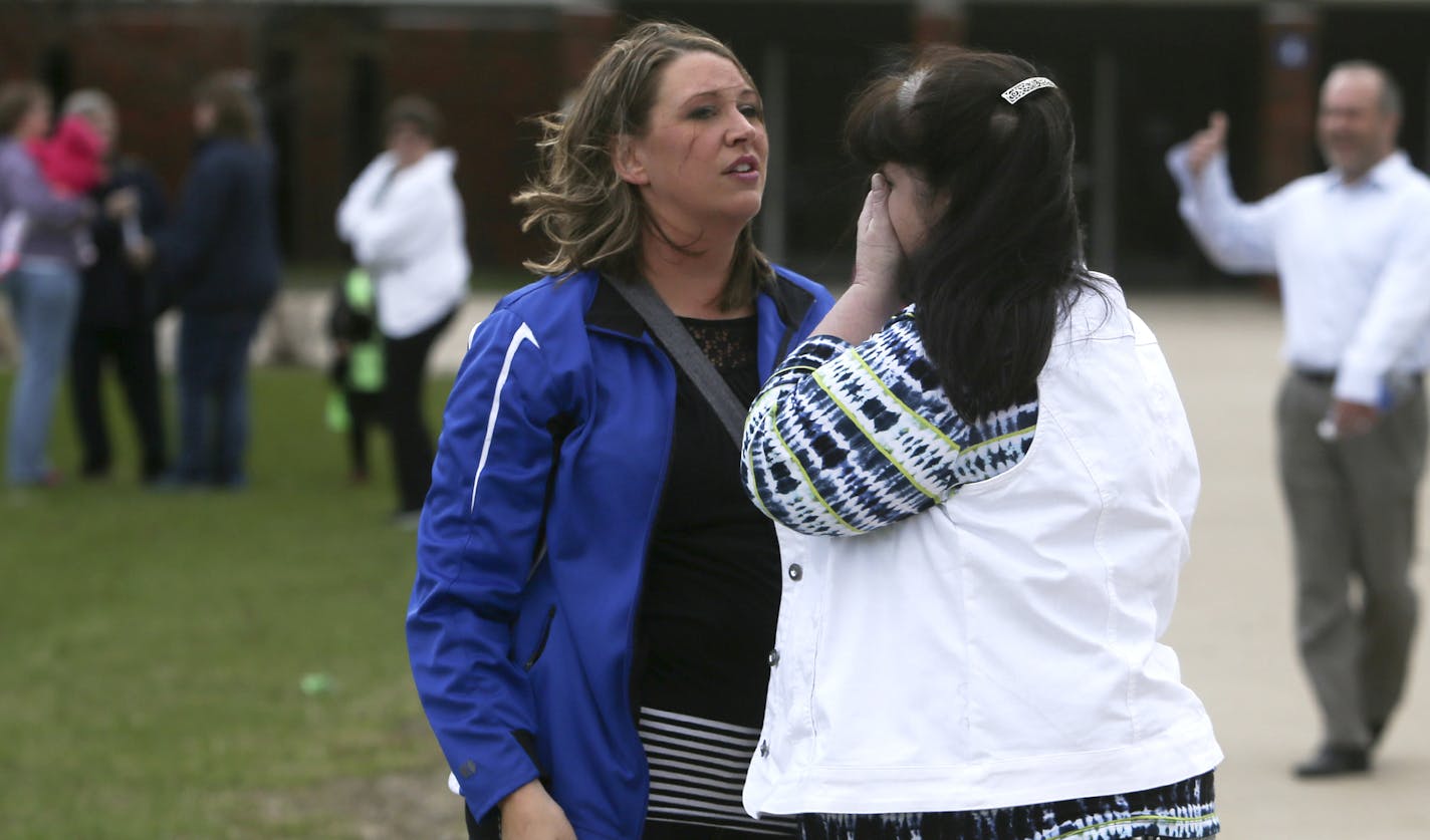 A day after a plot by 17 year-old Waseca High student John LaDue to kill his family and to massacre students in Waseca was uncovered and foiled, students, families and school officials met to discuss how the district will move forward Friday, May 2, 2014, at Waseca High School.Here, one parent consoles another who had become emotional following an evening meeting at the high school. "Thank God we're not planning funerals," the woman said to her friend. They did not want to be identified.](DAVID