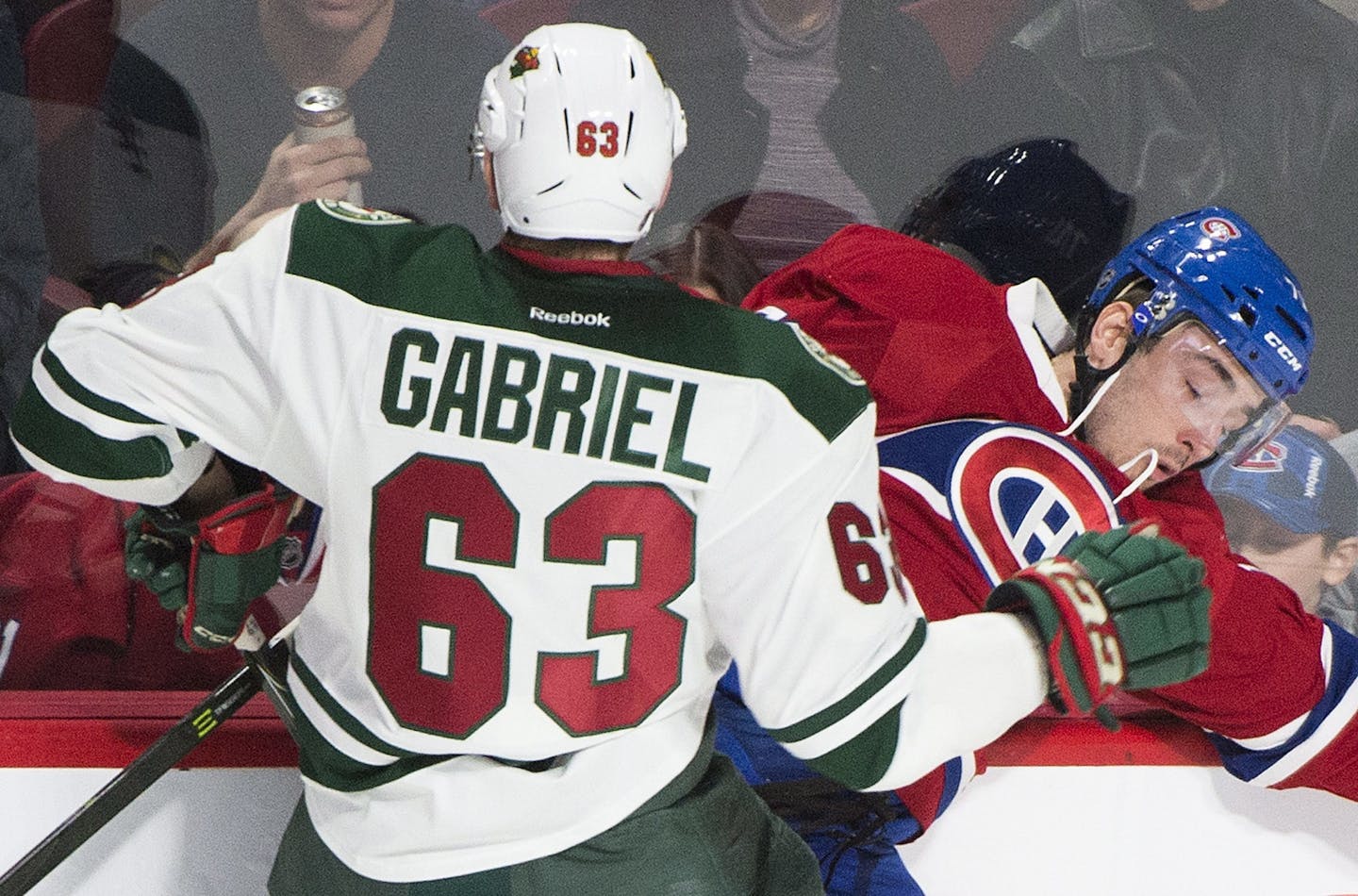 Minnesota Wild's Kurtis Gabriel checks Montreal Canadiens' Joel Hanley during first-period NHL hockey game action in Montreal, Thursday, Dec. 22, 2016.