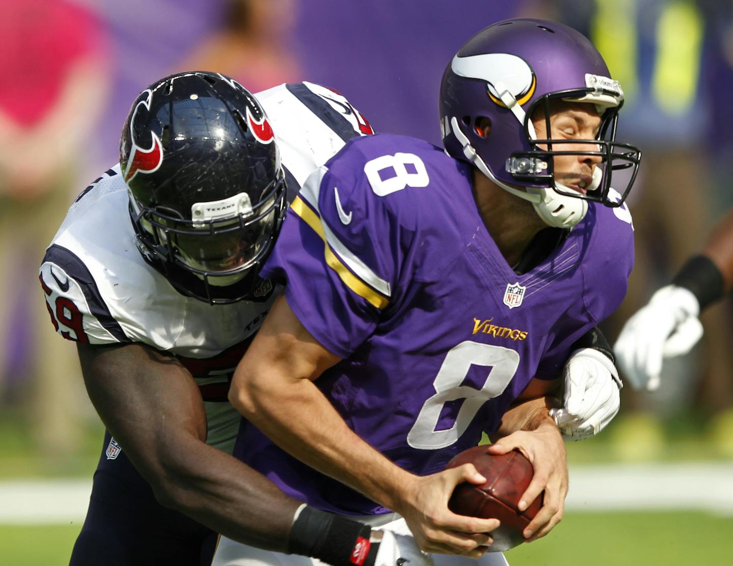 Minnesota Vikings quarterback Sam Bradford (8) is sacked by Houston Texans outside linebacker Whitney Mercilus, left, during the first half of an NFL football game, Sunday, Oct. 9, 2016, in Minneapolis. (AP Photo/Andy Clayton-King)