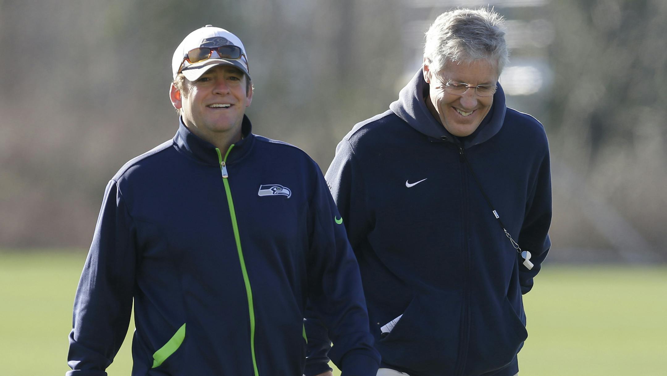 Seattle Seahawks general manager John Schneider, left, walks with head coach Pete Carroll, right, after NFL football practice, Friday, Jan. 24, 2014, in Renton, Wash. The Seahawks will play the Denver Broncos Feb. 2, 2014 in the Super Bowl. (AP Photo/Ted S. Warren) ORG XMIT: MIN2014012918071014