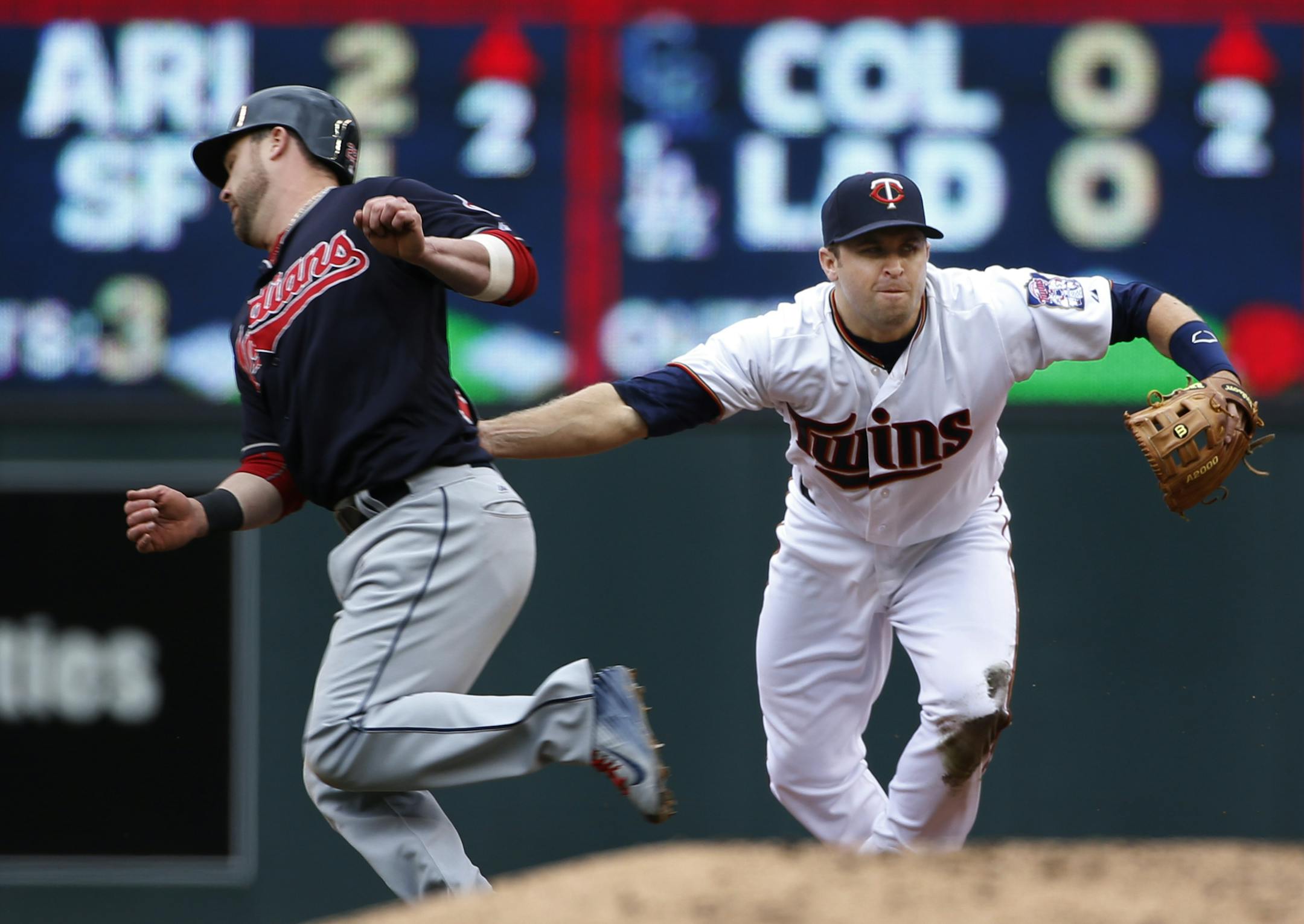 At Target Field in a game between the Indians and the Twins on April 9th, Jason Kipnis(22) is out on a double play as he is tagged by 2B Brian Dozier(2) in the 8th inning.] Richard Tsong-Taatarii/rtsong-taatarii@startribune.com