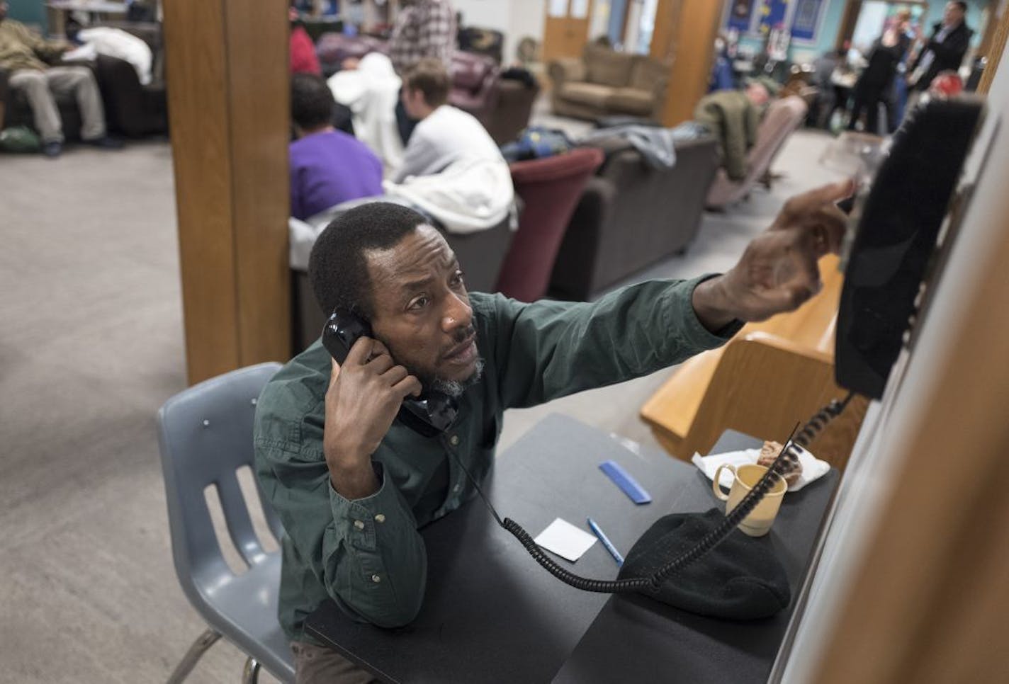 Benson Porter a client at Listening House, a drop-in center located in the basement of First Lutheran Church talked on the phone Monday Feb 26, 2018 in St. Paul, MN.