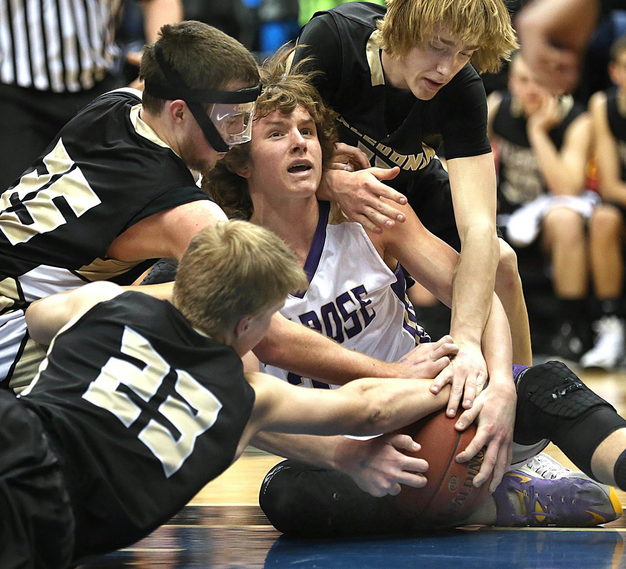 Melrose&#xed;s Drake Meyer was surrounded by Caledonia defenders, Kyle Sorenson (lower left), Austin Bauer and Colton Lampert (upper Right).] JIM GEHRZ &#xef; james.gehrz@startribune.com / Minneapolis, MN / March 14, 2015 /1:00 PM &#xf1;BACKGROUND INFORMATION: The Melrose Area High School Dutchmen played the Caledonia Warriors in the State Boys' Basketball Tournament Class 2A championship game at the Target Center.
