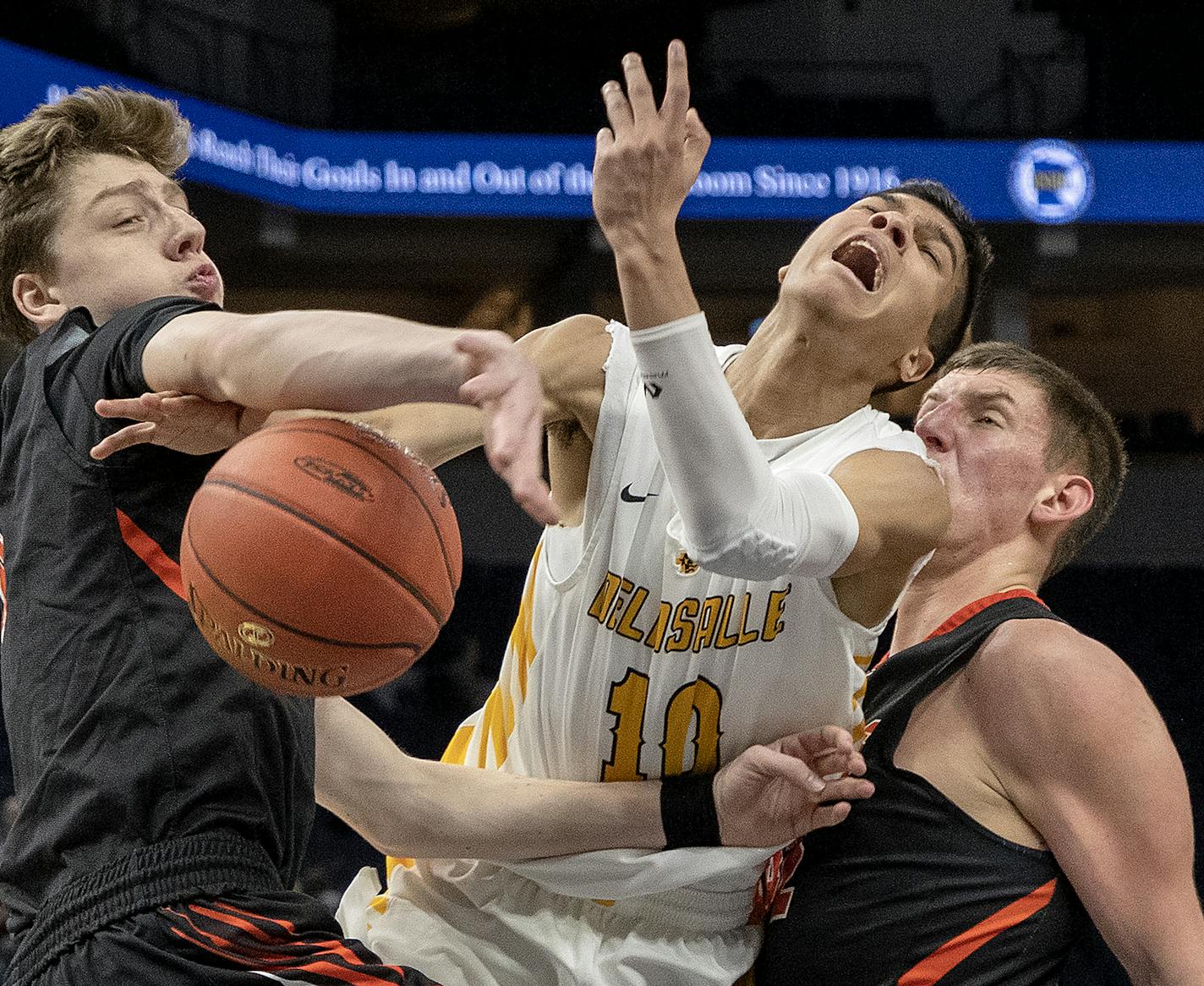 Tyrell Terry (10) was fouled by Reilly O'Neil (4) in the first half. ] CARLOS GONZALEZ &#x2022; cgonzalez@startribune.com &#x2013; Minneapolis, MN &#x2013; March 21, 2019, Target Center, High School / Prep Class 3A boys' basketball state tournament semifinals, Princeton Tigers vs. DeLaSalle Islanders