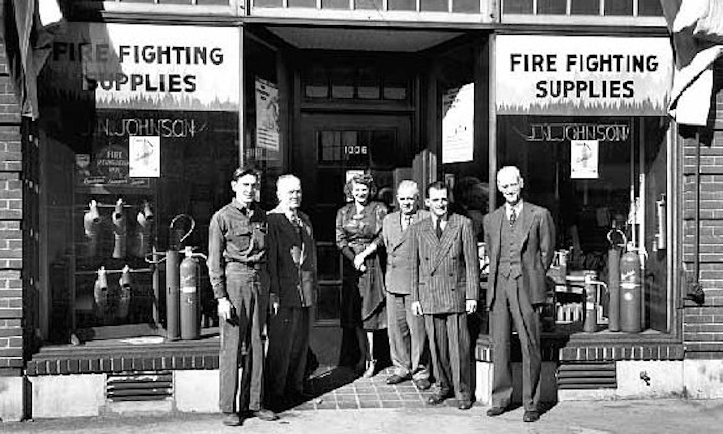 Employees of J.N. Johnson Incorporated stand in front of their shop at 1006 Marquette, one of the storefronts slated for demolition as part of plans for a new 18-story apartment tower, in this 1949 photo. (This is a 1949 picture of the same storefront where "marquette062115" was shot, featuring James Patrick)