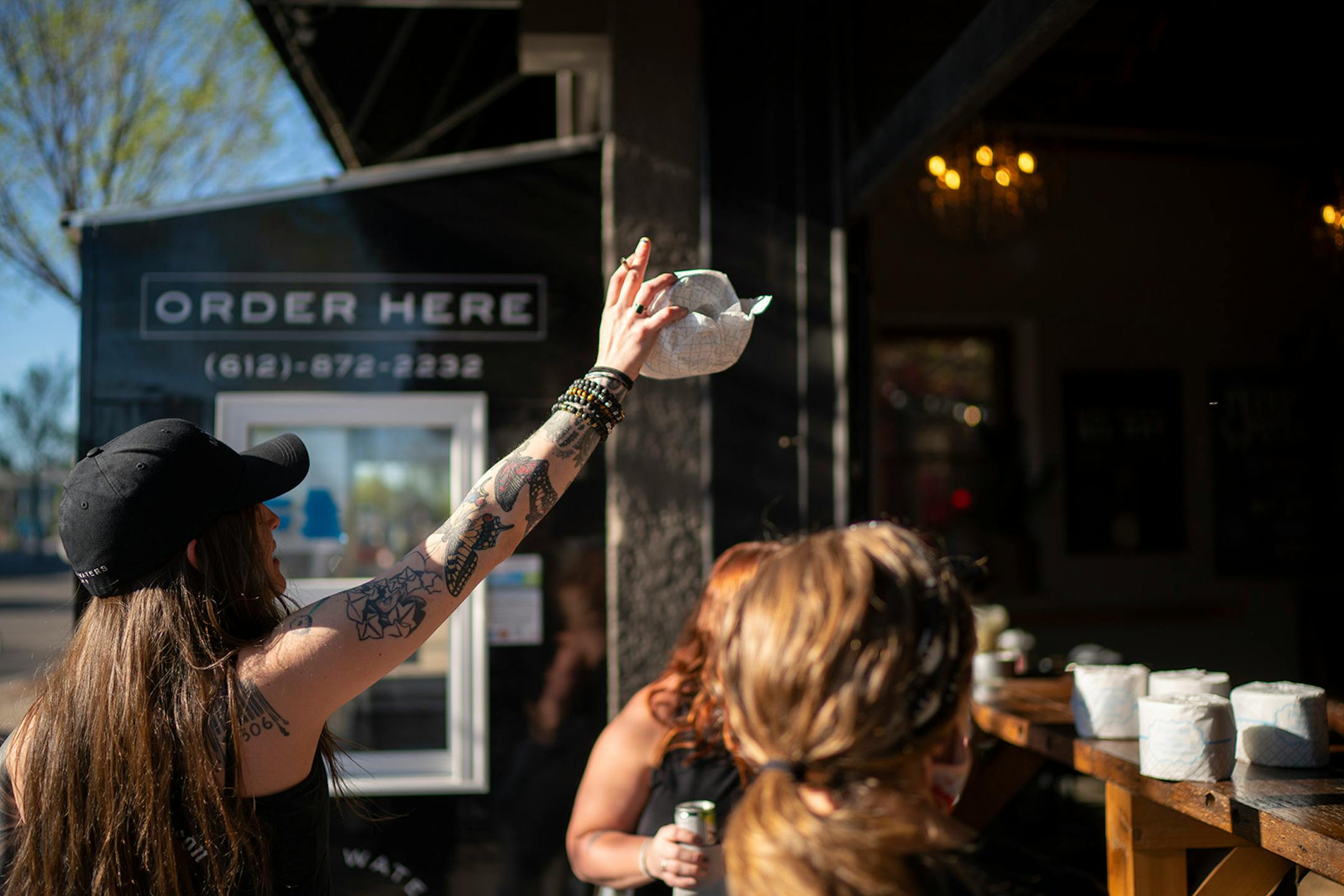 A happy recipient of a roll of toilet paper thanked the employees inside. It was an emotional scene at Muddy Waters early Sunday afternoon, May 3, 2020 as loyal customers and former employees mingled on the last day of service at the beloved bar and restaurant in the Lyn-Lake area.