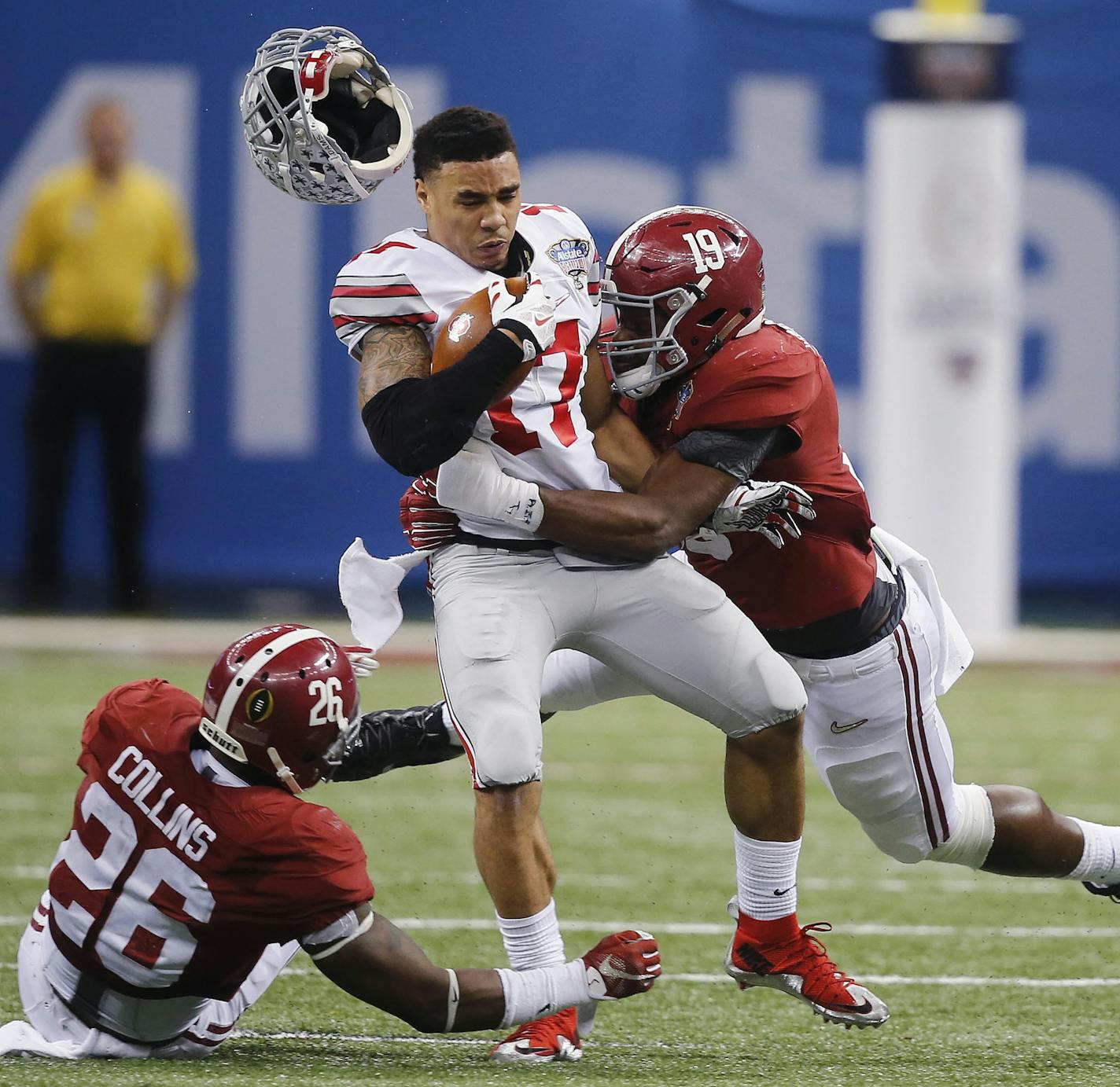 Ohio State running back Jalin Marshall (17) is hit by Alabama linebacker Reggie Ragland (19) as Alabama defensive back Landon Collins (26) looks on in the second half of the Sugar Bowl NCAA college football playoff semifinal game, Thursday, Jan. 1, 2015, in New Orleans. (AP Photo/Bill Haber)