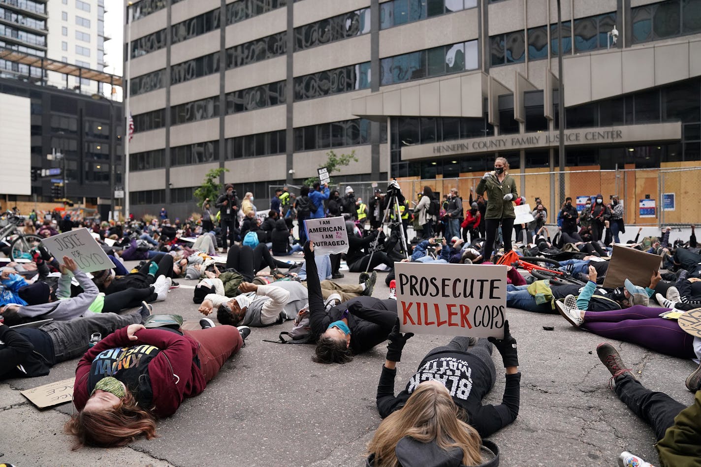 Protesters staged a die in outside the Hennepin County Family Justice Center as family and defendants arrived for a hearing on several pending motions in the cases against four former Minneapolis officers in the killing of George Floyd. ] ANTHONY SOUFFLE • anthony.souffle@startribune.com A judge heard oral arguments on several pending motions in the cases against four former officers in the killing of George Floyd, including motions to dismiss the cases, Friday, Sept. 11, 2020 at the Hennepin Co