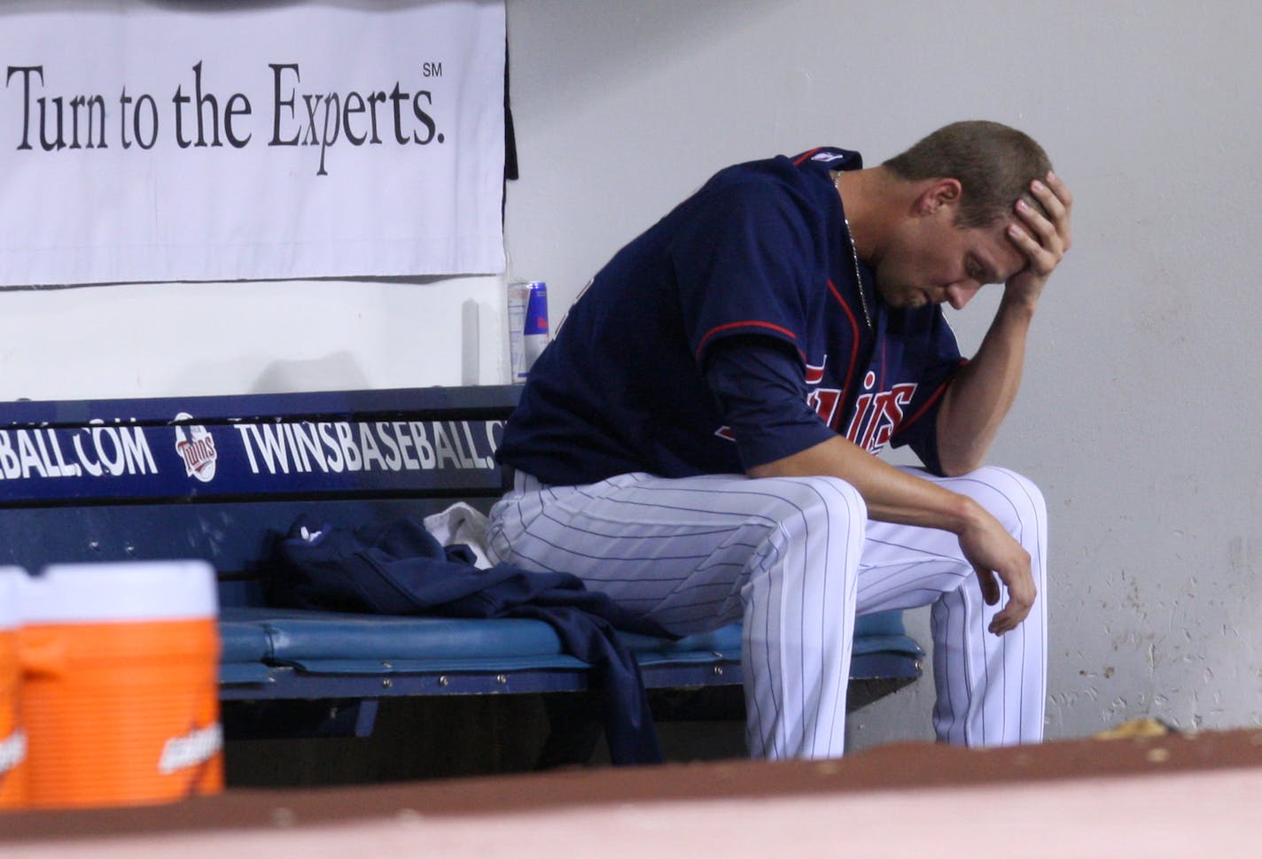 Matt Guerrier sat dejectedly in the Twins dugout after giving up three runs in the 12th inning.