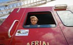 Five-year old Oliver Kewatt from Andover peeked out of the window from inside Columbia Heights Fire Department's Aerial Truck 1 during an open house e