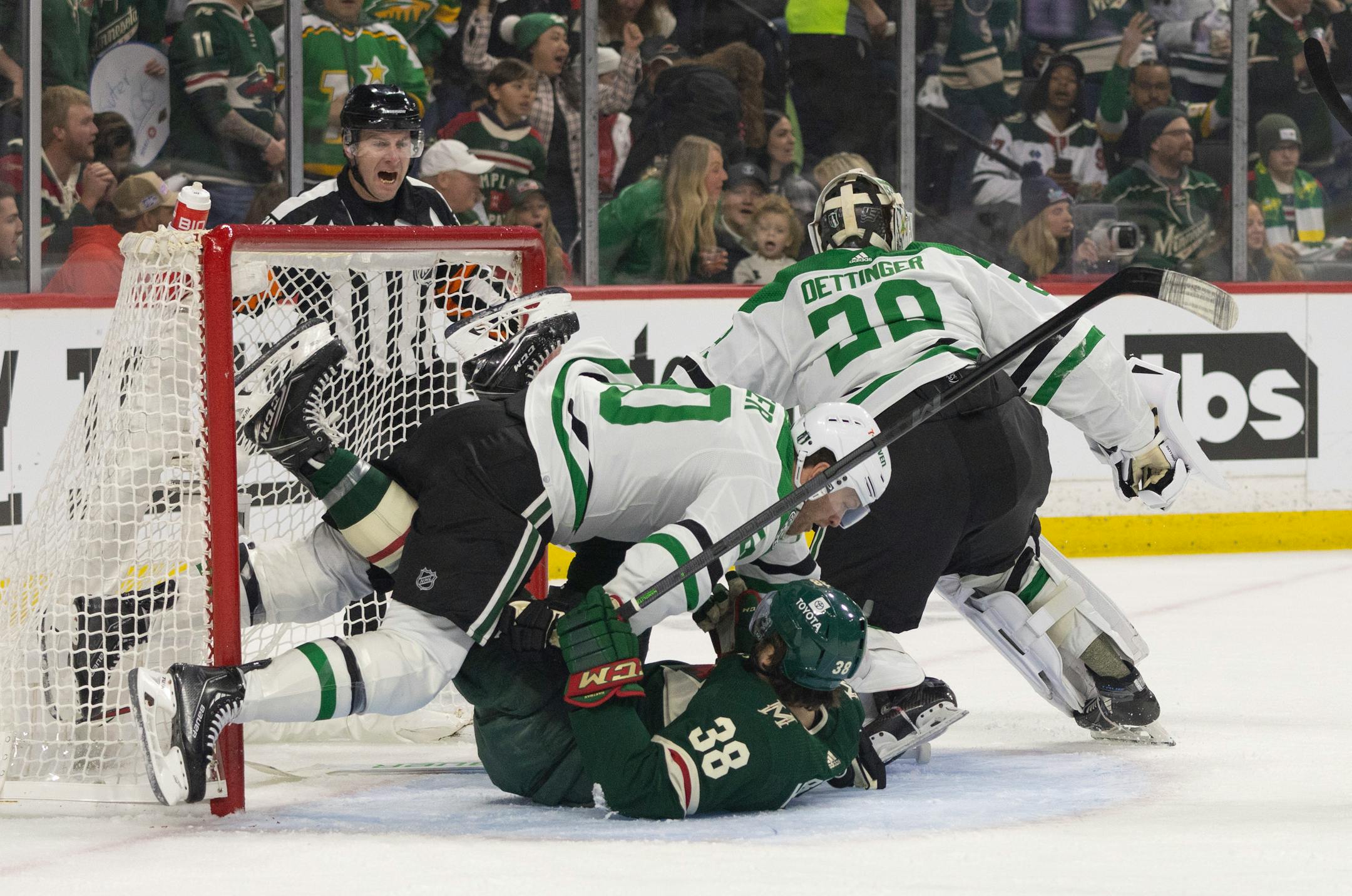 Dallas Stars defenseman Ryan Suter (20) took down Minnesota Wild right wing Ryan Hartman (38) in the crease in the first period. The Minnesota Wild faced the Dallas Stars in Game 6 of an NHL hockey Stanley Cup first-round playoff series, Friday night at Xcel Energy Center in St. Paul.