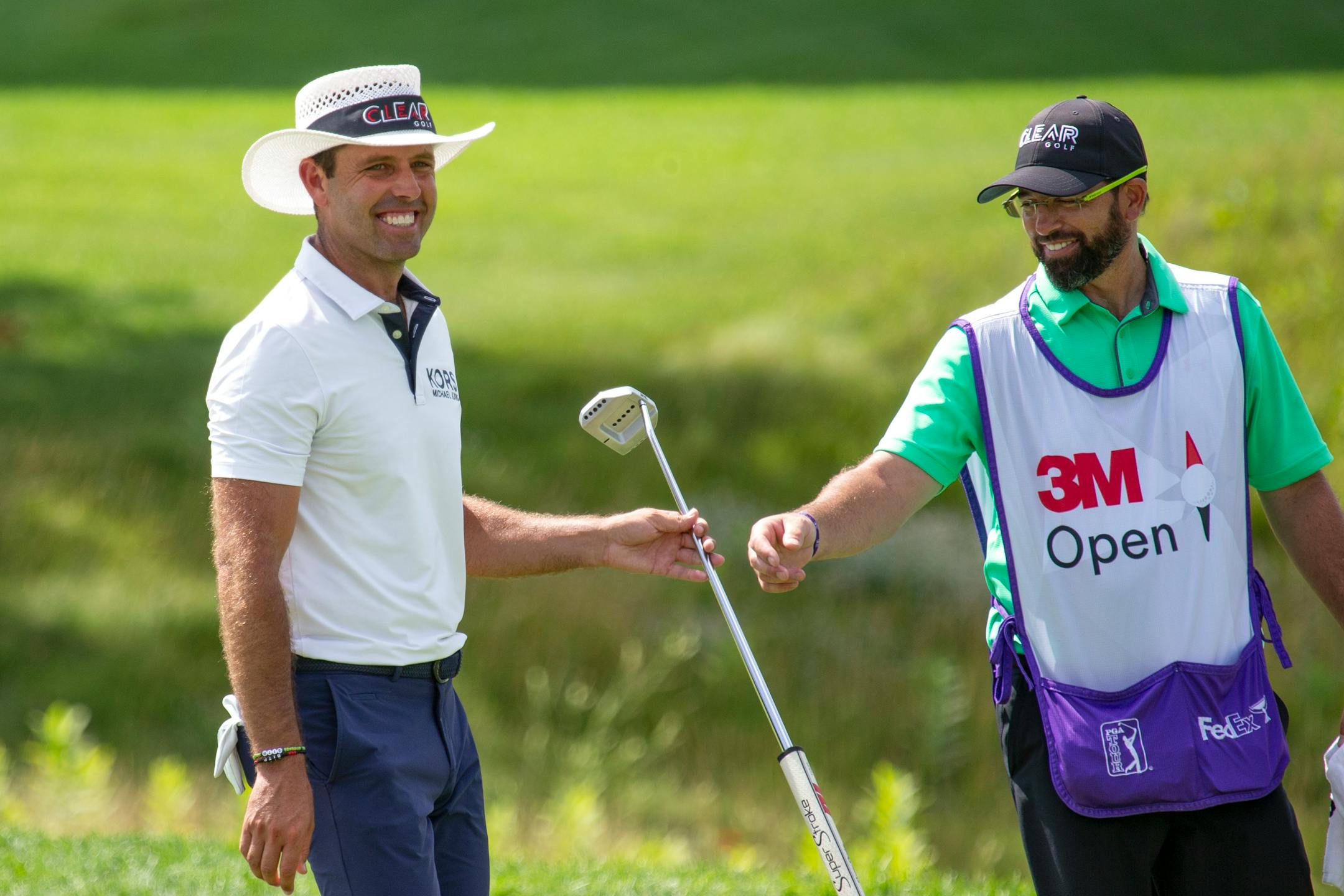 Charl Schwartzel and his caddie smile after Schwartzel birdied the 13th hole during the final round of the 3M Open golf tournament in Blaine, Minn., Sunday, July 26, 2020. (AP Photo/Andy Clayton-King)