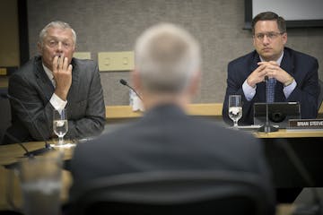 FILE -- University of Minnesota regent Steve Sviggum, left, and Brian Steeves, executive director of the regents board, listened during a regents meet