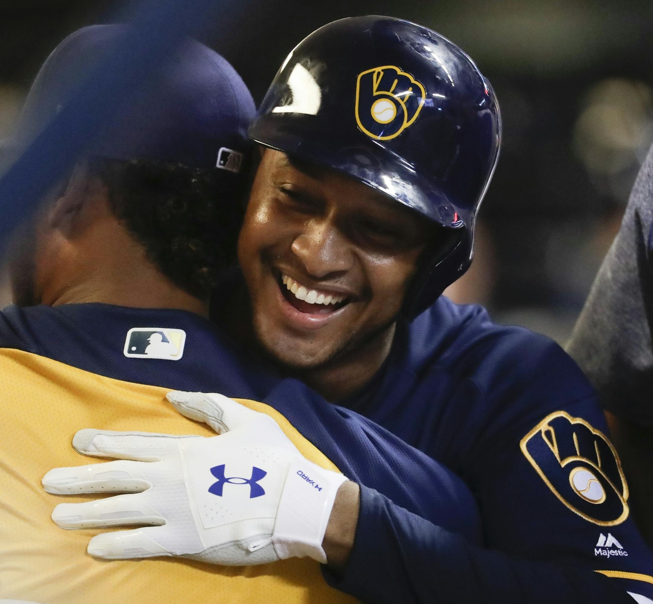 Milwaukee Brewers' Jonathan Schoop is congratulated after hitting a home run during the eighth inning of a baseball game against the Cincinnati Reds Tuesday, Aug. 21, 2018, in Milwaukee. (AP Photo/Morry Gash) ORG XMIT: WIMG117