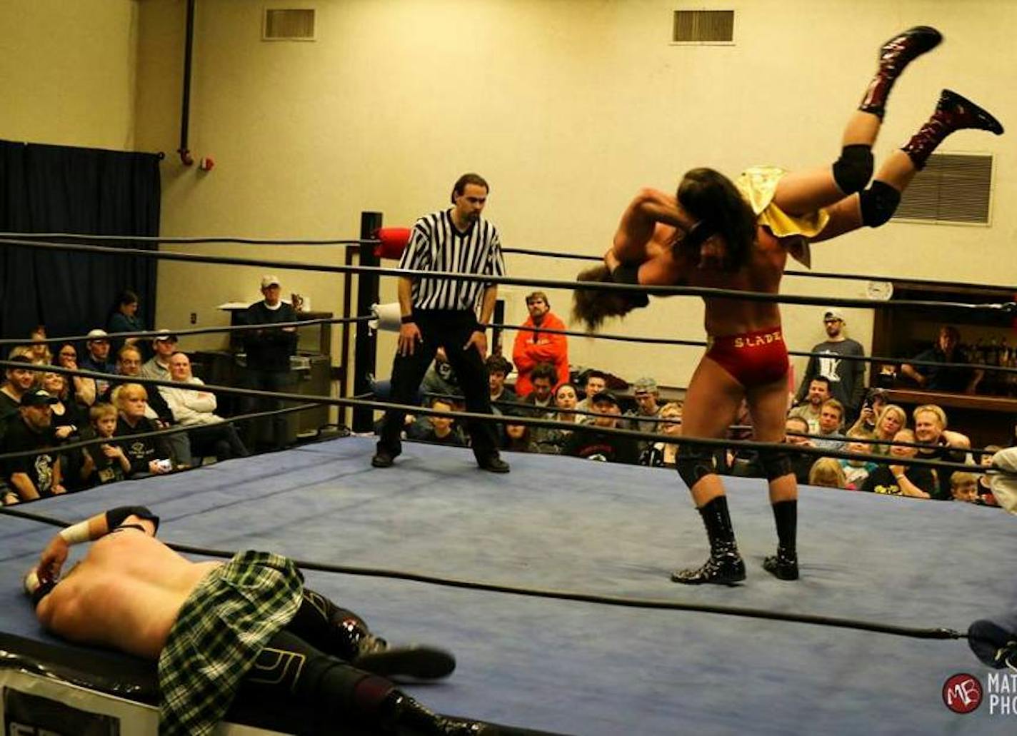 Ryan Slade prepared to body-slam Tommy Lee Curtis on a recent Steel Domain Wrestling card as referee Jesse Johnson watched. Aaron Corbin, meantime, writhed on the ring apron in agony.