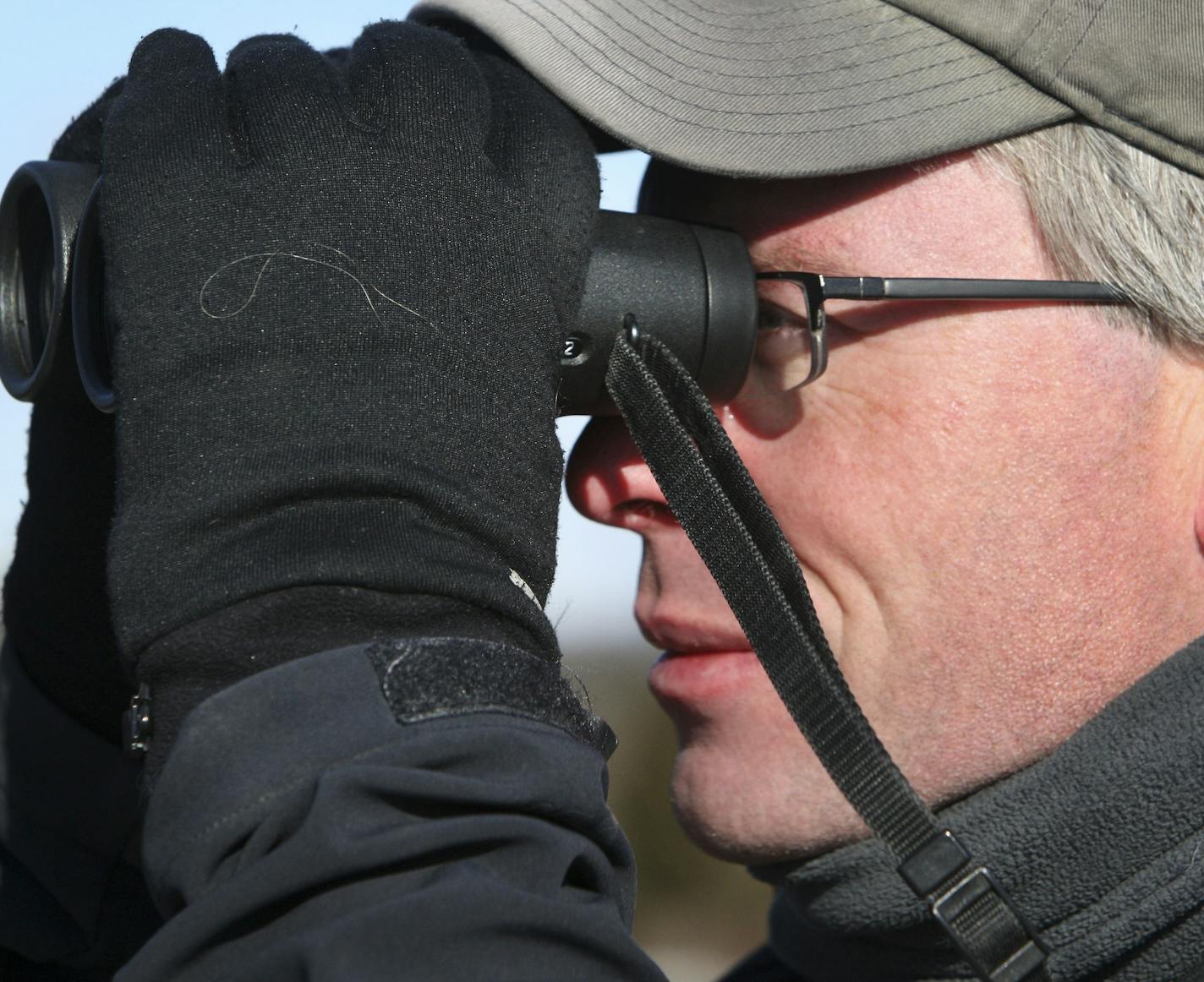 AP MEMBER FEATURE EXCHANGE ADVANCE FOR JAN. 11-12 -- In this Jan. 1, 2014 photo, birdwatcher Neil Hayward, of Cambridge, Mass., gazes through binoculars at the Parker River National Wildlife Refuge on Plum Island, Mass. Hayward possibly set an American Birding Association record by observing 749 different birds in 2013. (AP Photo/The Boston Globe, John Blanding) BOSTON HERALD OUT, QUINCY OUT; NO SALES