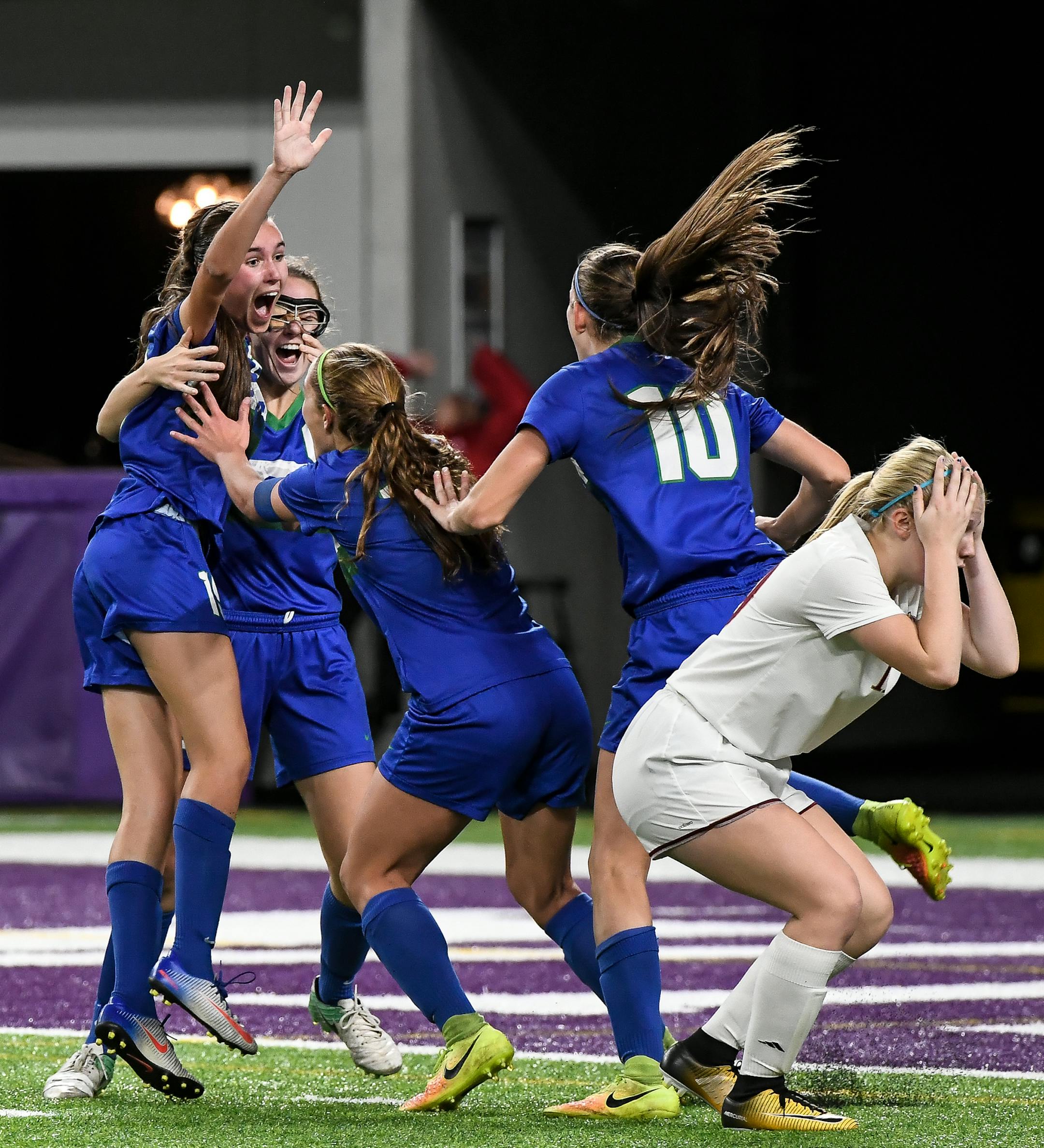 Teammates celebrated with Eagan midfielder Ellen Pagois (15), far left, after she scored the game winning goal against Maple Grove with :06 second left on the clock in the second half. ] AARON LAVINSKY ï aaron.lavinsky@startribune.com Eagan played Maple Grove in the Class 2A girls' soccer championship game on Thursday, Nov. 2, 2017 at US Bank Stadium in Minneapolis, Minn.