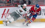 Minnesota Wild's Nick Seeler slides into the boards next to Montreal Canadiens' Joel Armia during third period