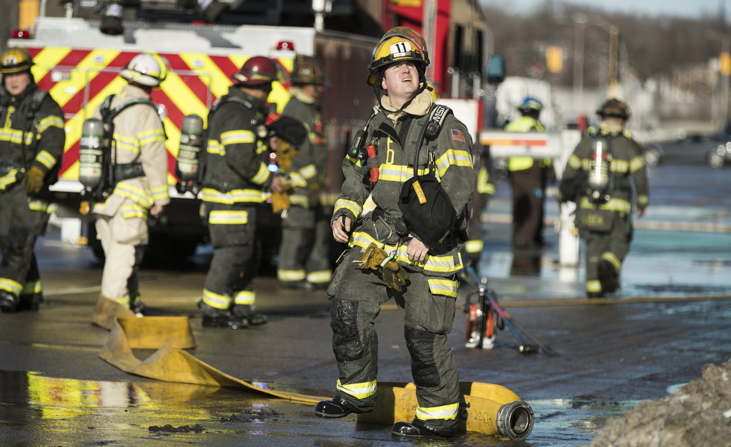 Fire personnel ready a hose outside of Minneapolis Metal Recycling during a fire. ] (Leila Navidi/Star Tribune) leila.navidi@startribune.com BACKGROUND INFORMATION: A recycling plant in north Minneapolis caught fire Tuesday, December 20, 2016, sending up huge clouds of smoke and leading to traffic disruptions, authorities said. The blaze broke out about 10:10 a.m. at Northern Metal Recycling in the 1800 block of 2nd Street N., according to the Fire Department.