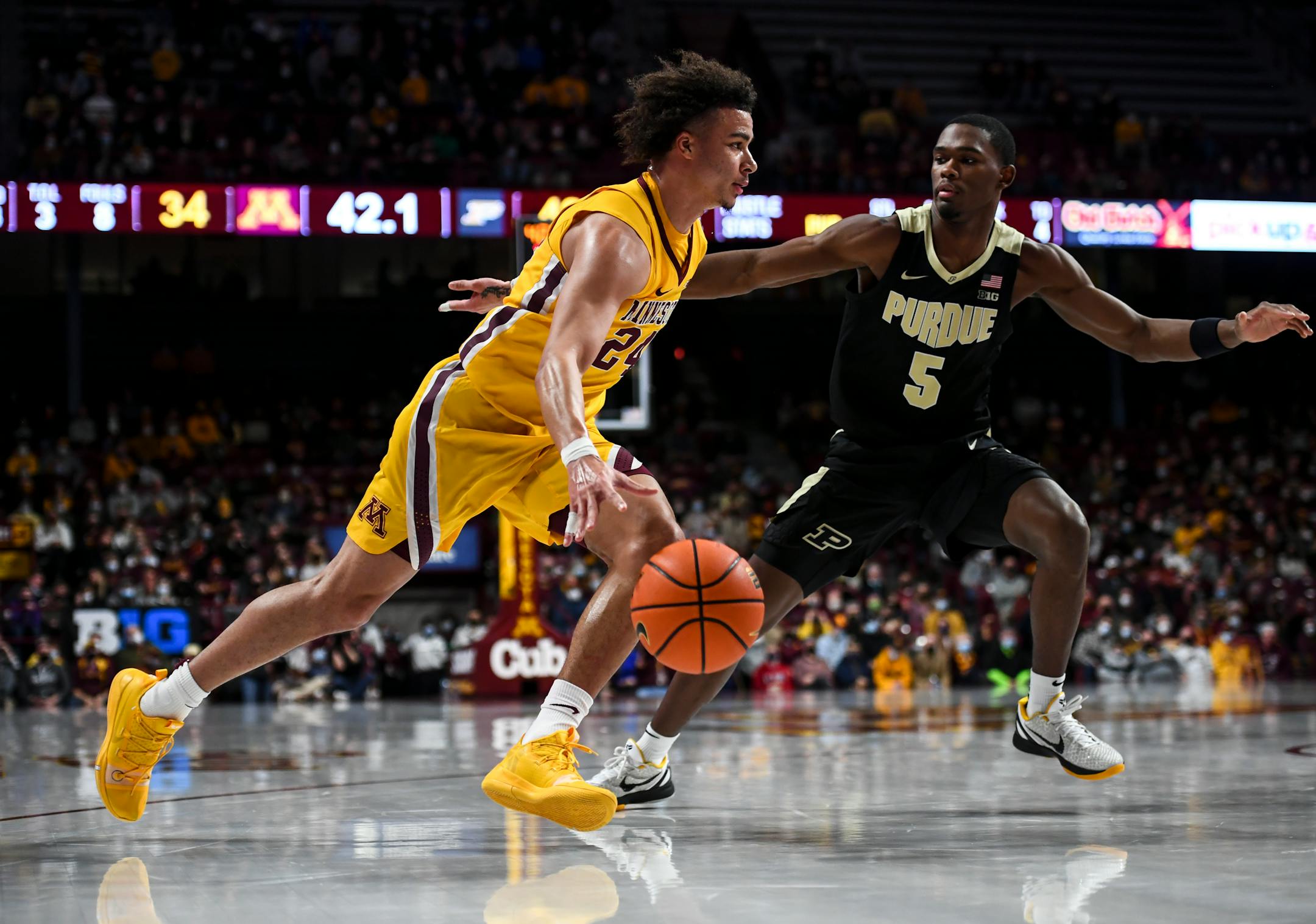 Minnesota Gophers guard Sean Sutherlin (24) drives toward the basket during the first half of an NCAA men's basketball game between Minnesota and Purdue at Williams Arena in Minneapolis, Minn.