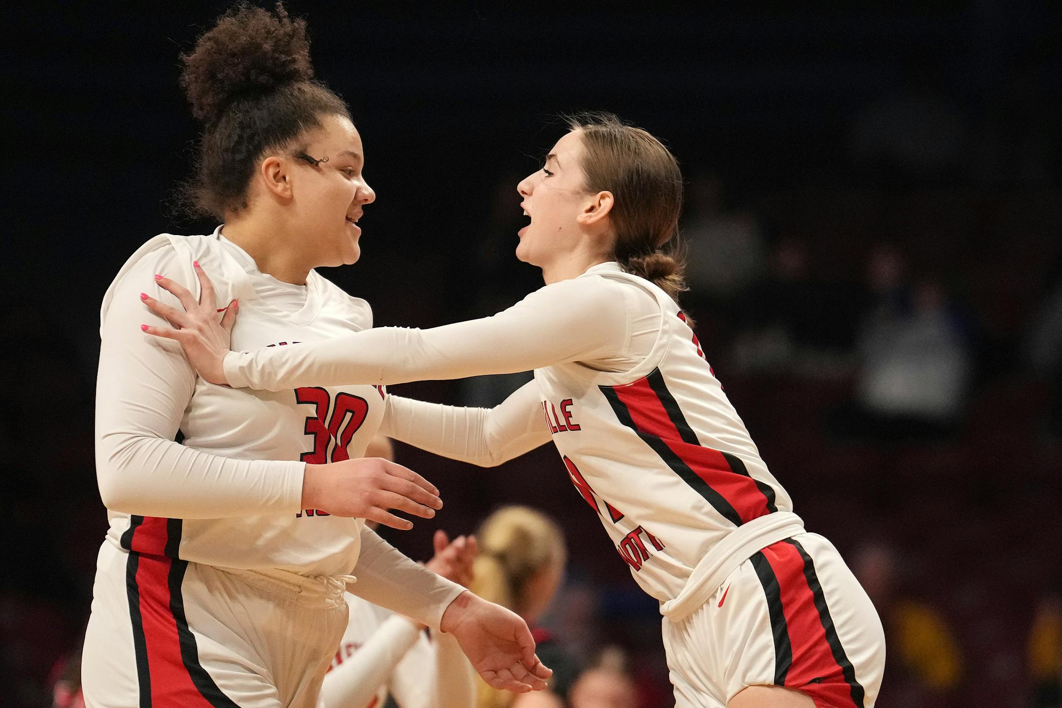 Lakeville North guard Emelia Wolkow congratulated forward Trinity Wilson (30) after Wilson scored several baskets early in the first half of a MSHSL girls basketball quarterfinal game between Lakeville North and Stillwater Wednesday, March 15, 2023 at Williams Arena in Minneapolis. ] ANTHONY SOUFFLE • anthony.souffle@startribune.com