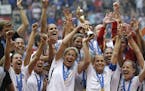 FILE - In this July 5, 2015, file photo, the United States Women's National Team celebrates with the trophy after they beat Japan 5-2 in the FIFA Wome